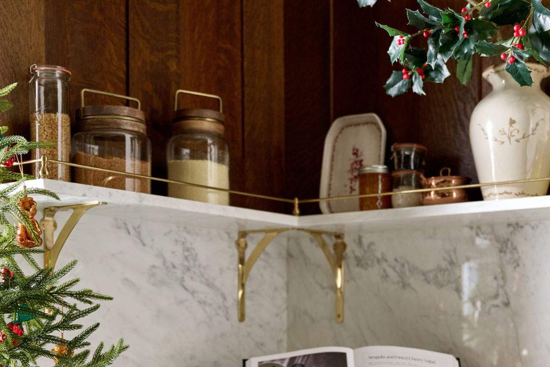 shop kitchen tools and storage. Image features a utensil crock with wooden spoons on counter.