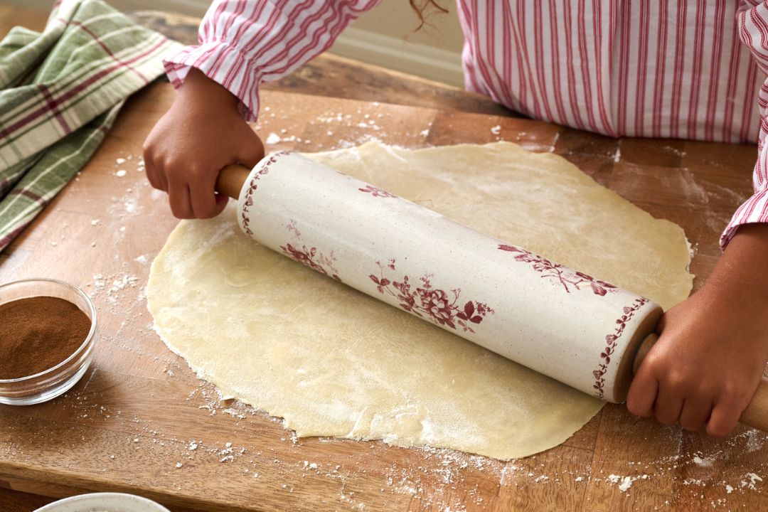 Shop bakeware. Image features a mixing bowl with measuring spoons and ingredients.