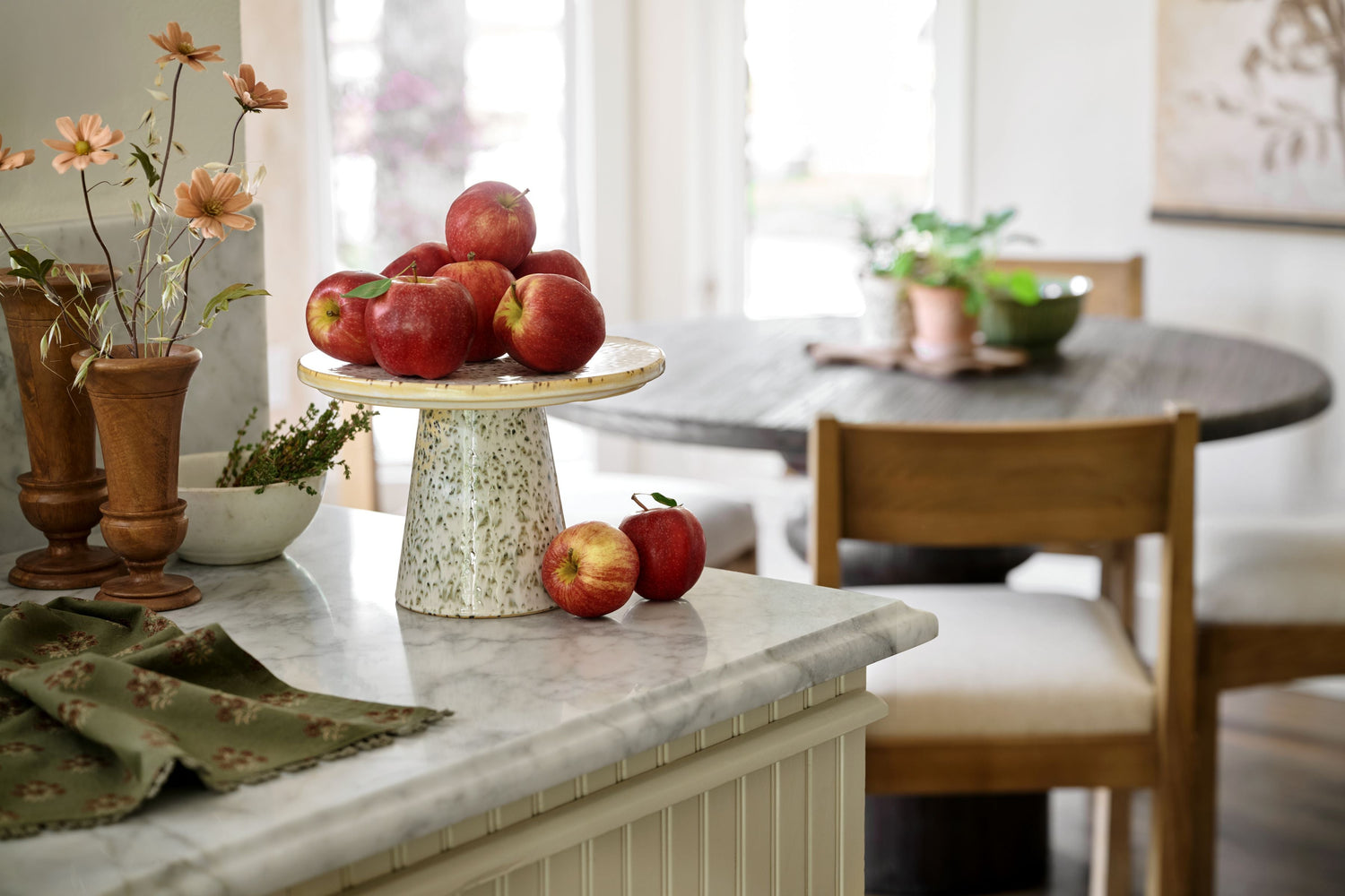 Shop cake stands and plates. Image features a green speckled cake stand holding apples