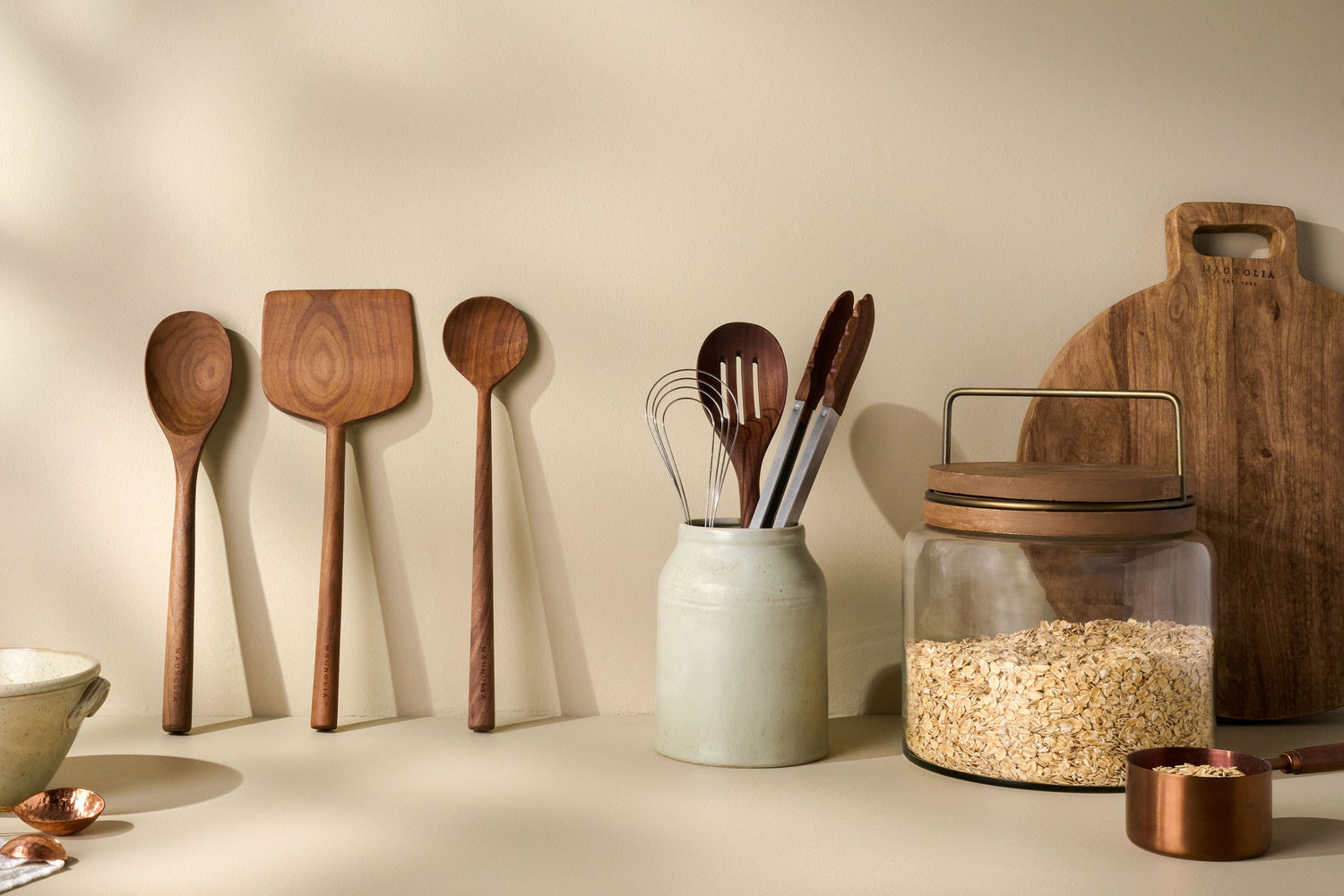 Shop kitchen utensils. Image features various wooden spoons, turners and whisks.