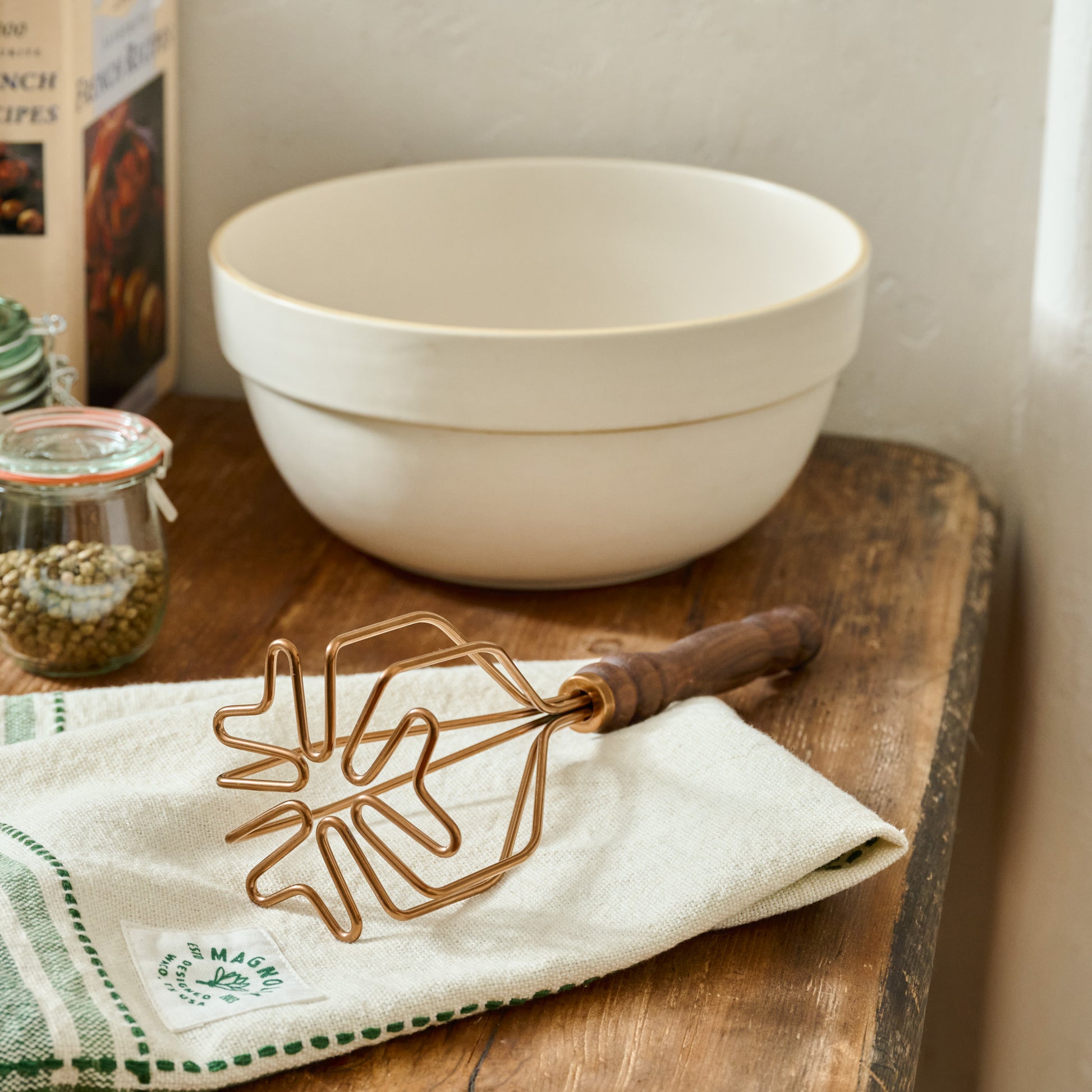 Walnut Handle Copper Potato Masher shown on countertop