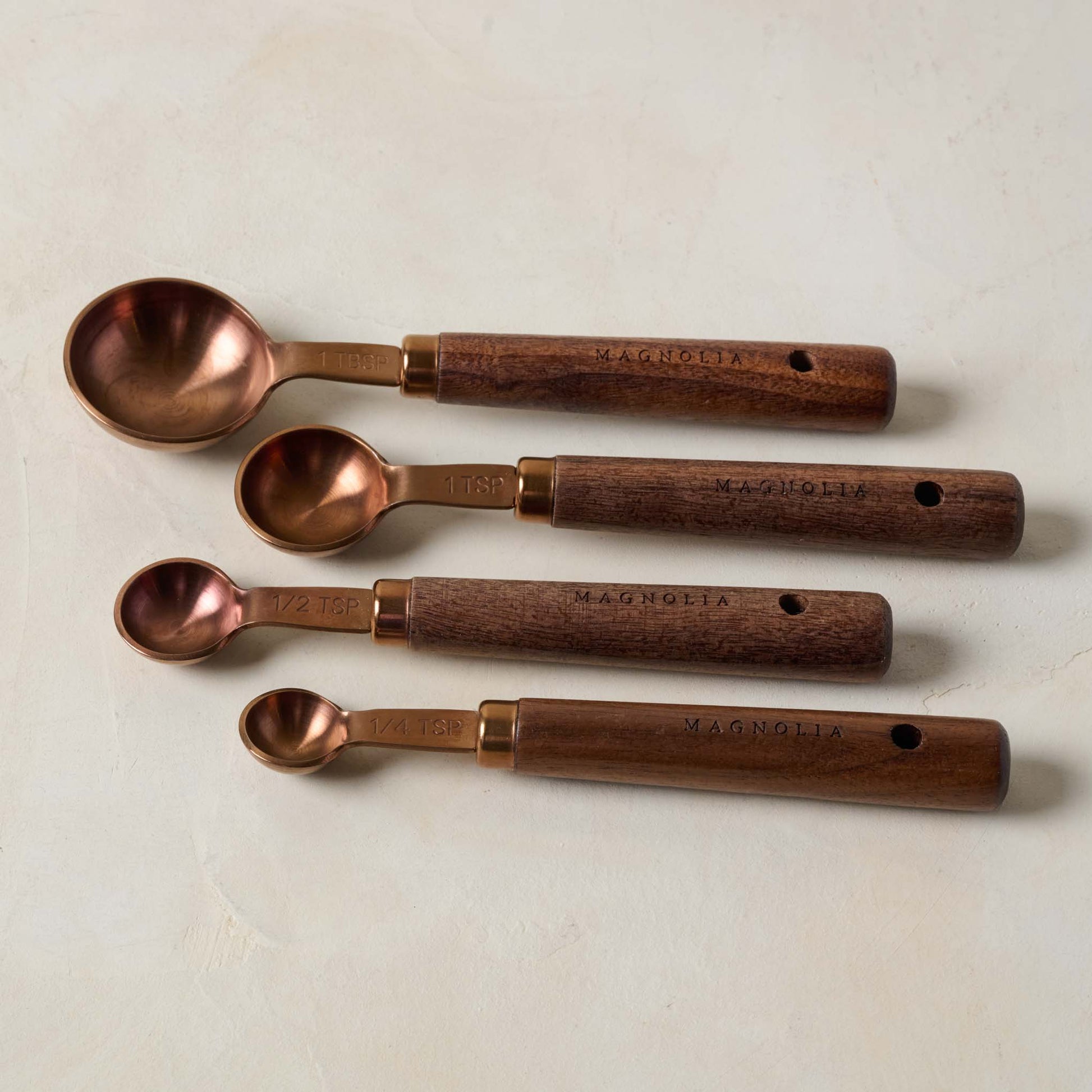 Walnut and Copper Measuring Spoons laid out separately