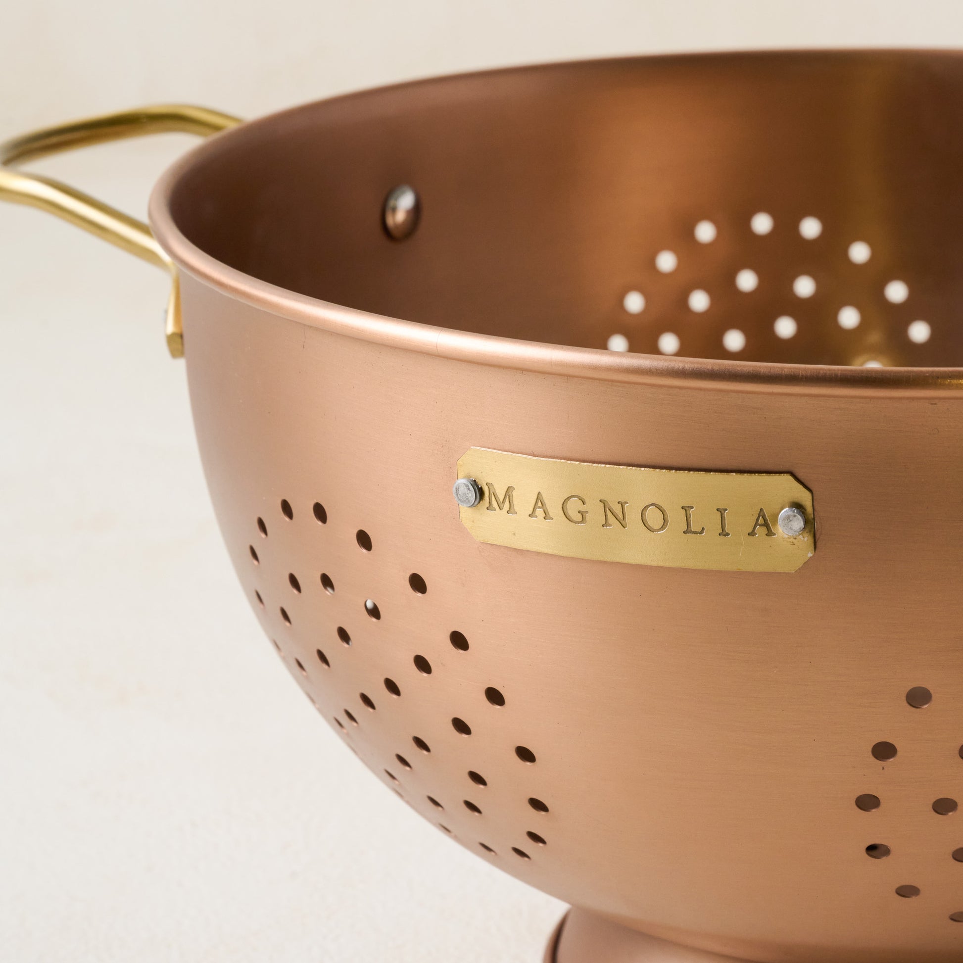 Copper and Brass Colander close up of magnolia logo