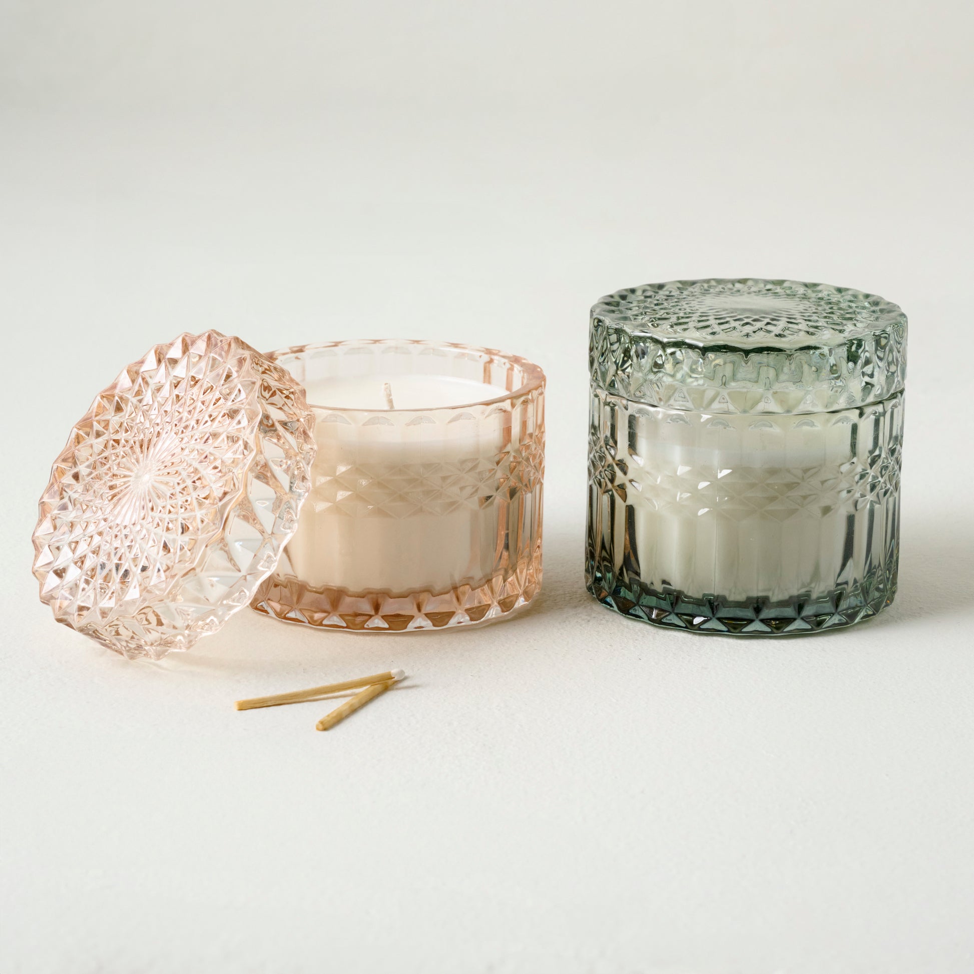 Magnolia Morning Light Glass Candle shown with another cut glass candle