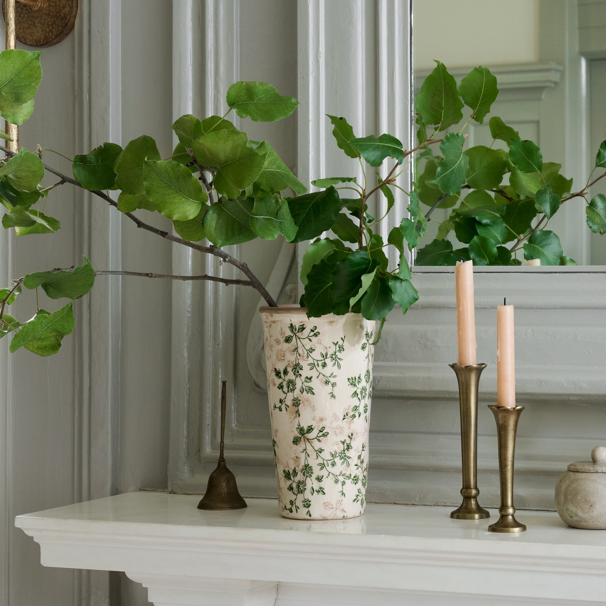 flannery scalloped brass bud vase with tapers sitting on mantel