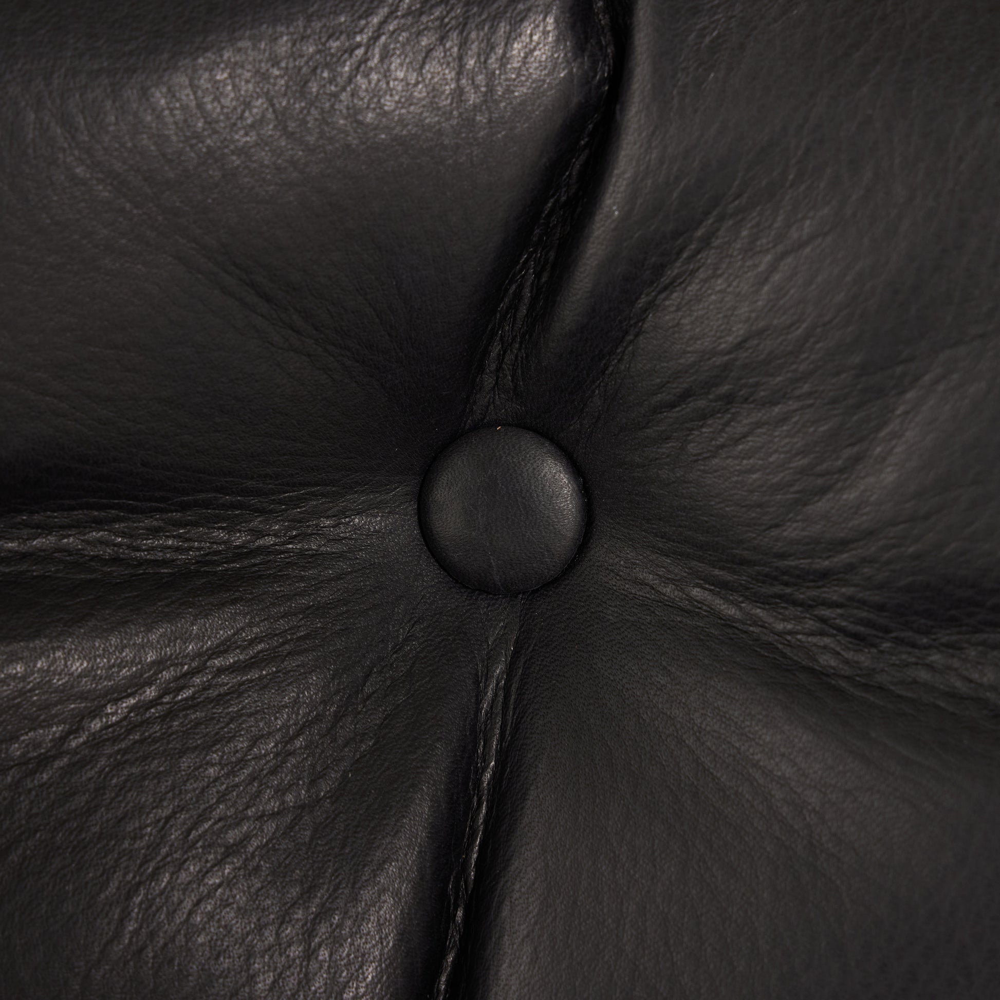 Flynn Chair heirloom black leather close up of button on chair
