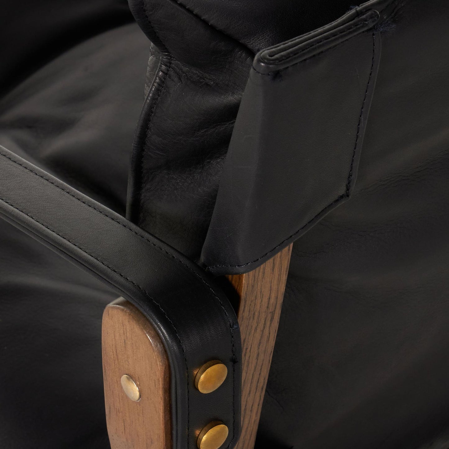 Flynn Chair heirloom black leather close up of back of arm rest