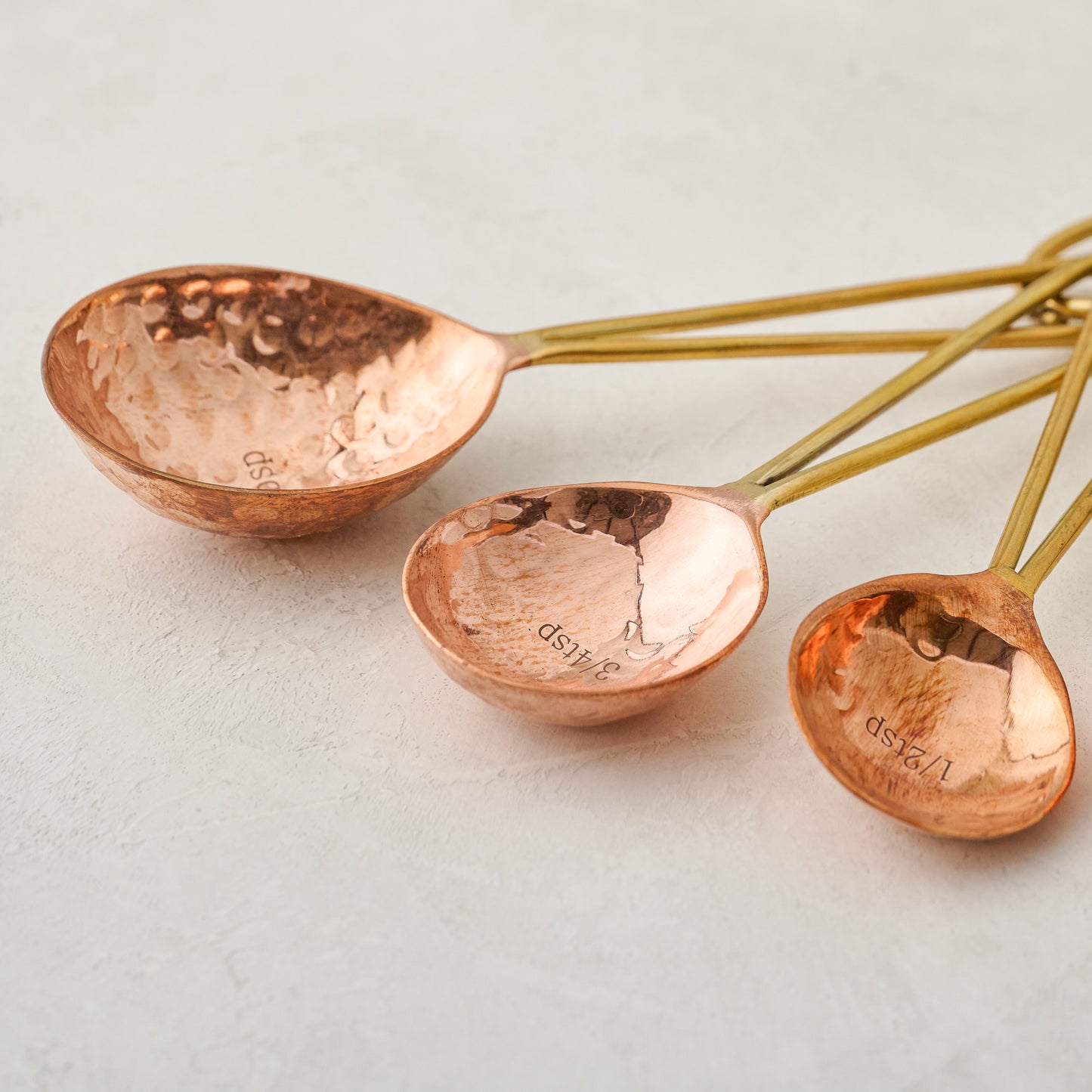 close up view of Hammered Copper and Gold Measuring Spoons