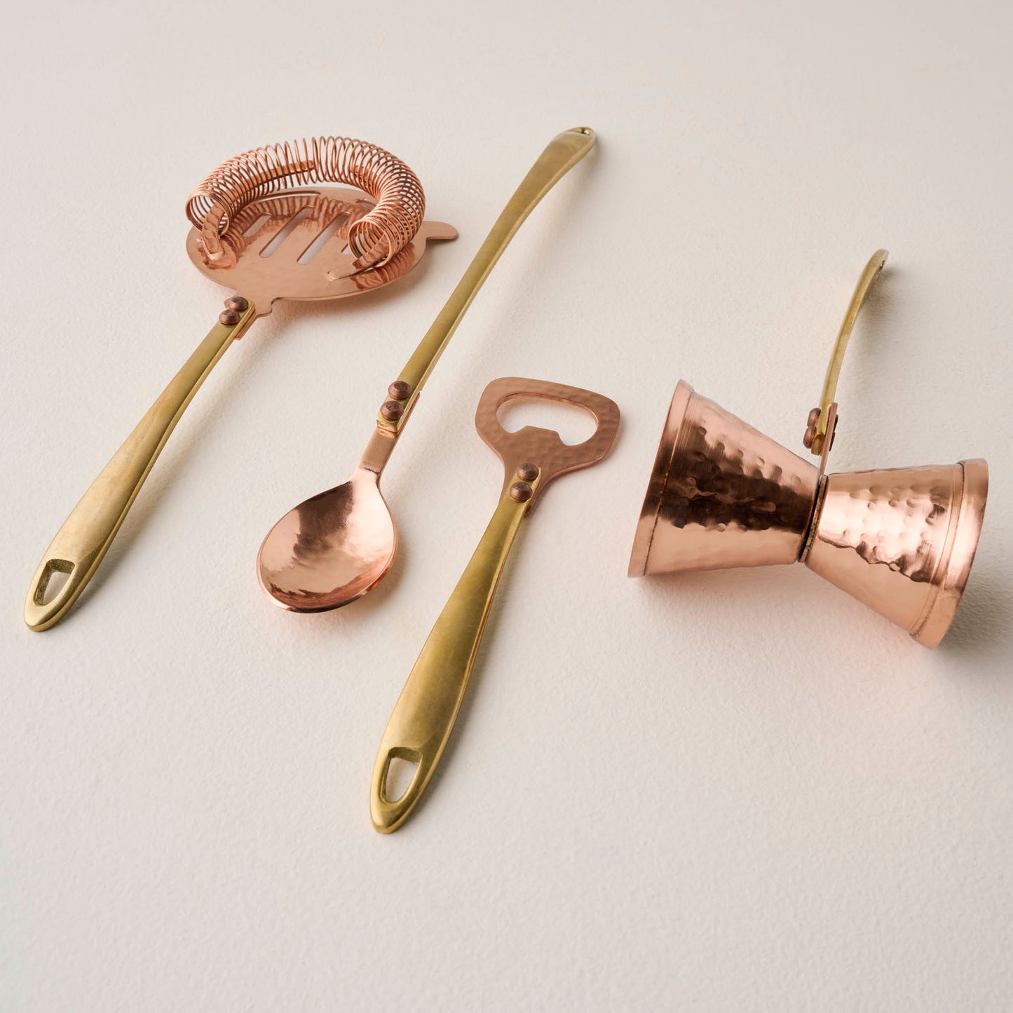 Hammered Copper and Gold Jigger shown with other bar tools