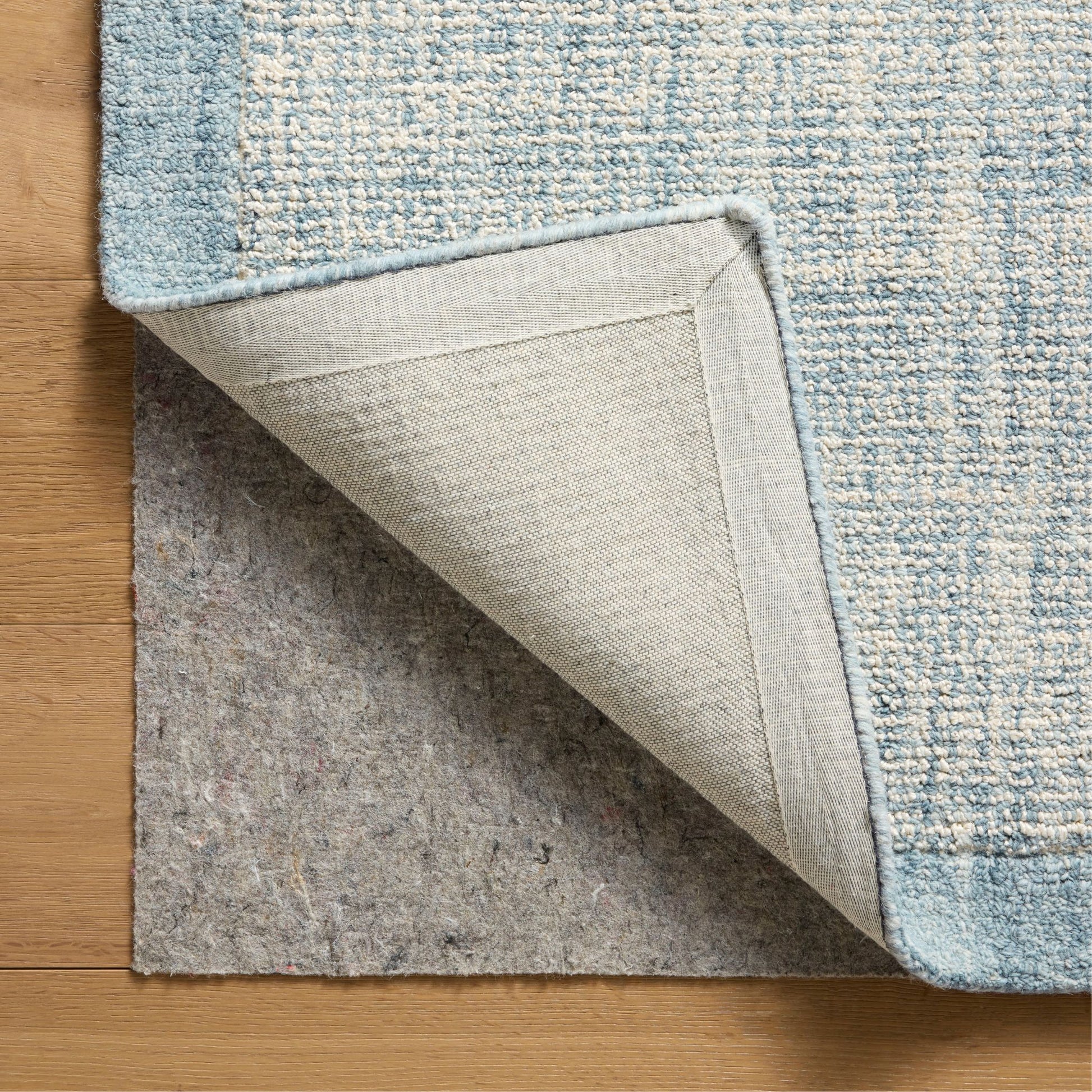 Henley Ivory Blue Rug corner shown flipped