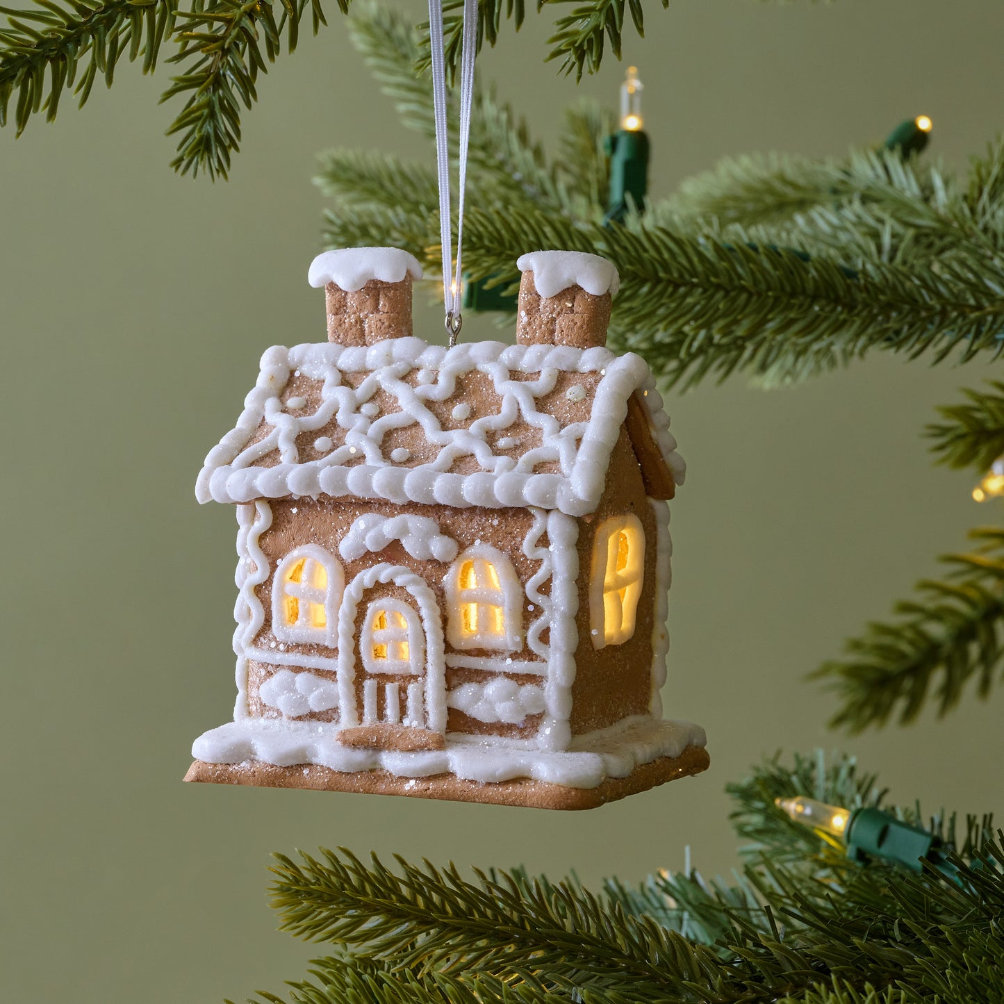 Cottage Gingerbread House Ornament shown on tree