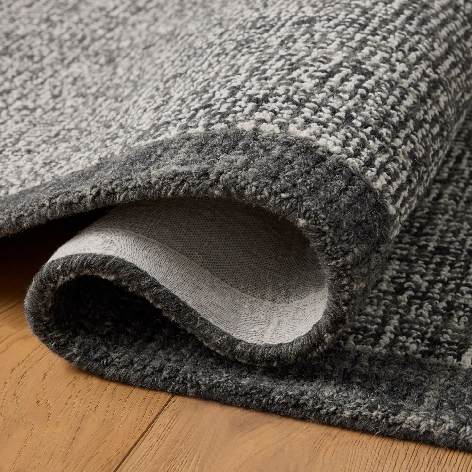 Henley Ivory Charcoal Rug shown folded