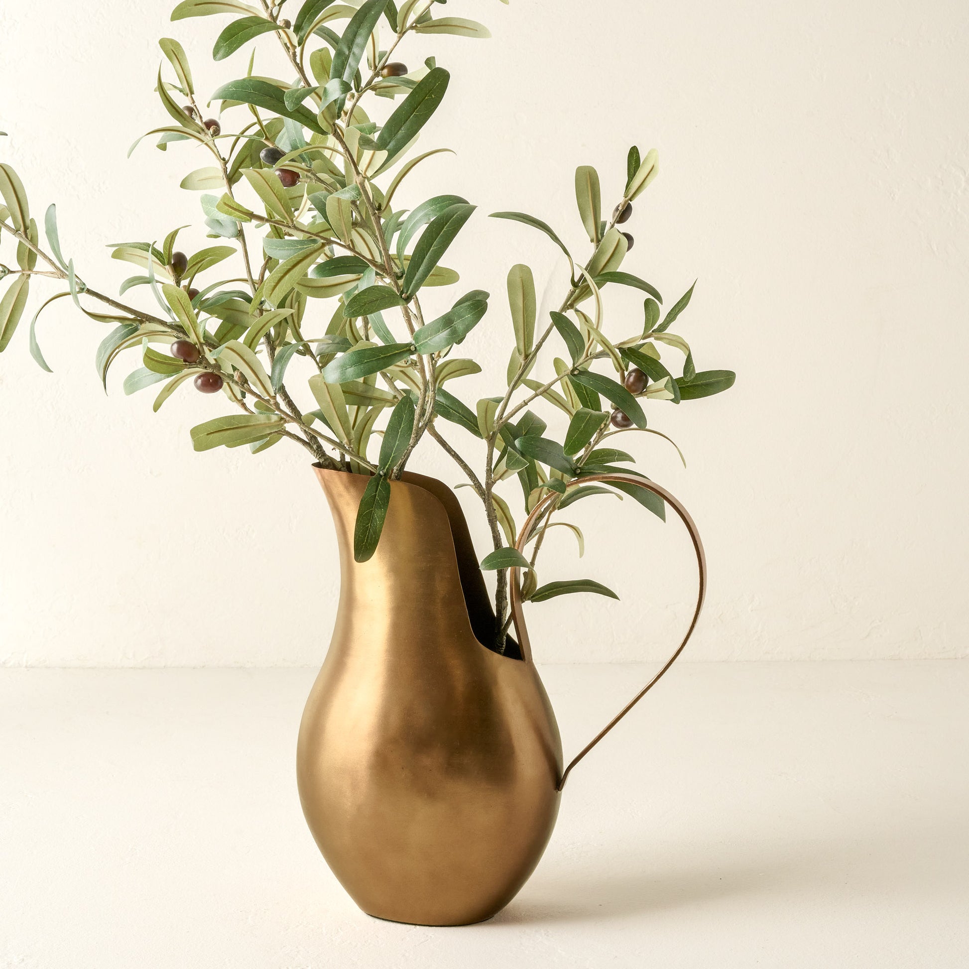 Antique Brass Pitcher Vase shown holding olive plant