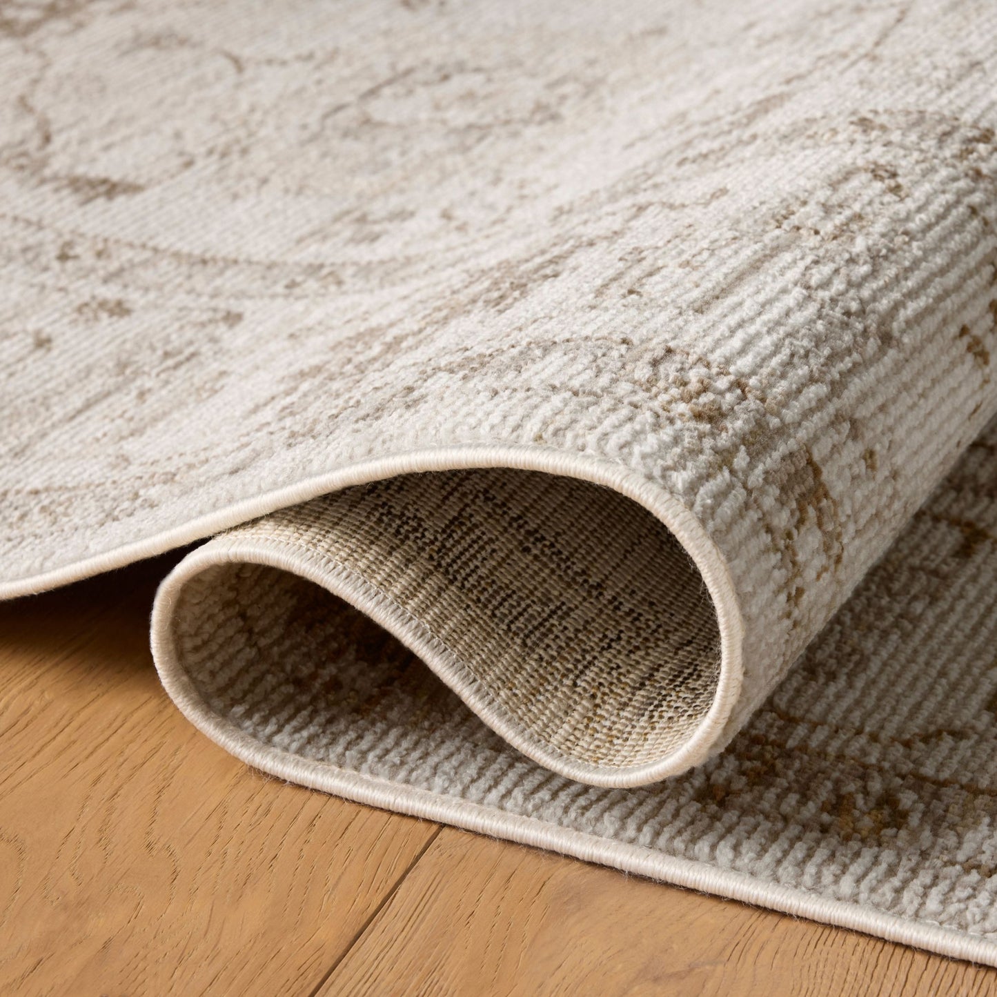 Pace Natural Stone Rug shown rolled/folded