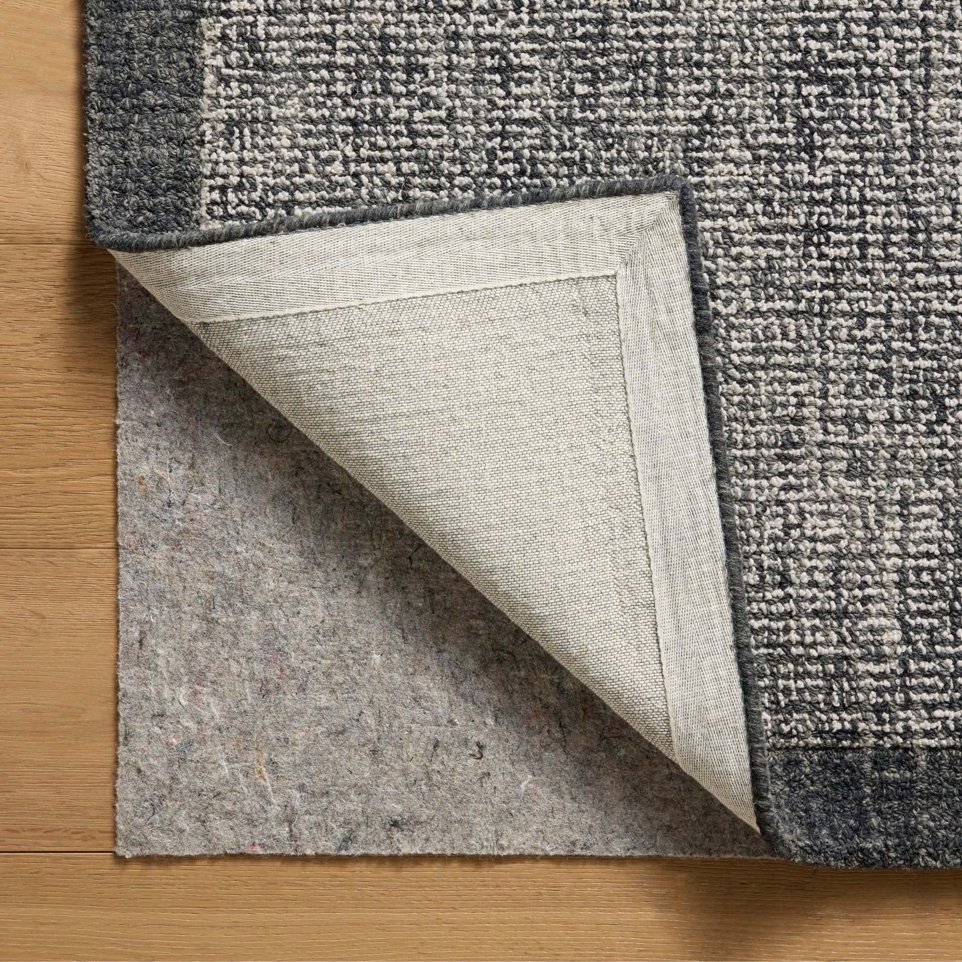 Henley Ivory Charcoal Rug corner shown flipped