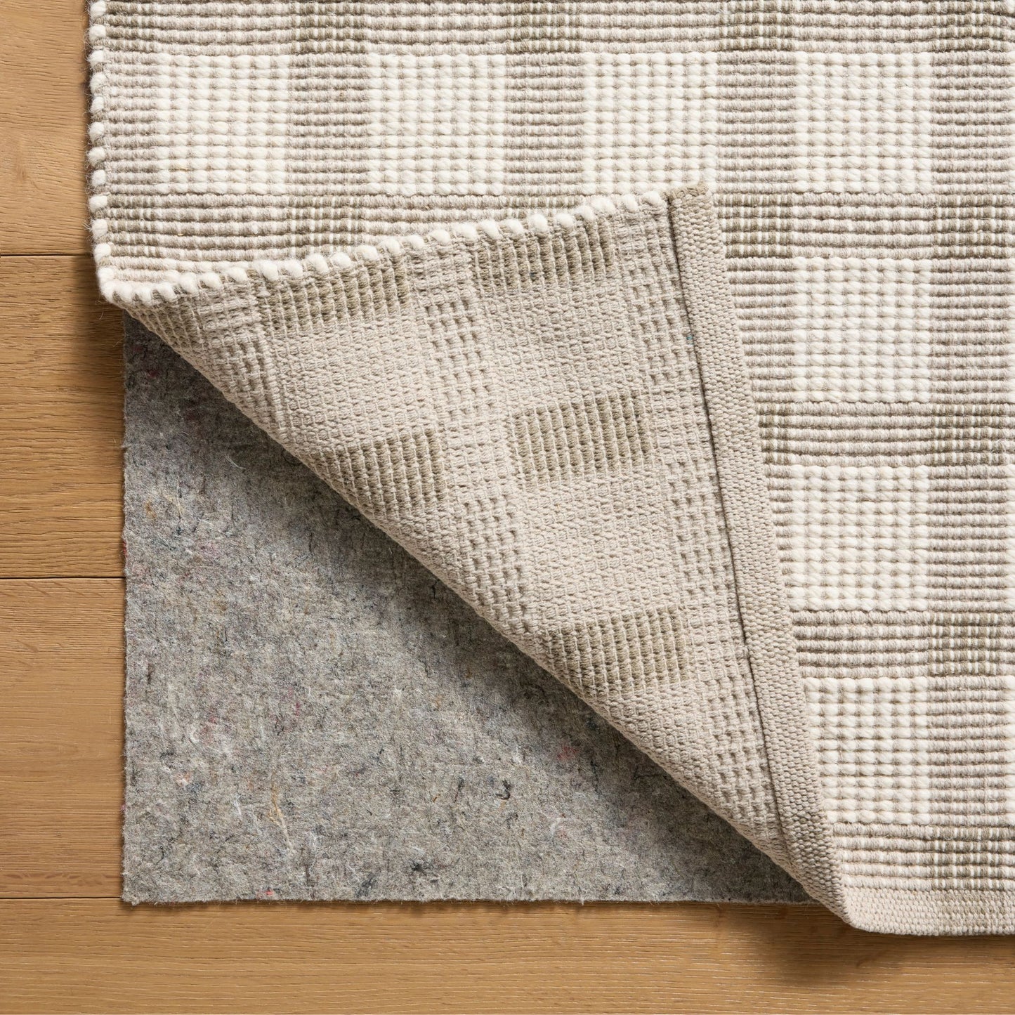Ryder Stone Ivory Rug corner shown folded