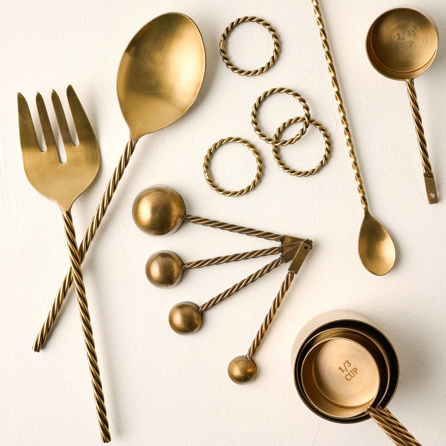 Antique Brass Twisted Measuring Cups shown with other antique brass twisted product