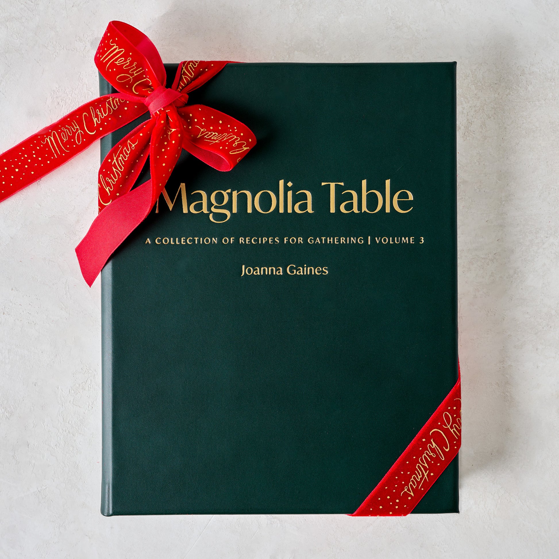 Leather Bound Magnolia Table Cookbook Volume 3 shown with ribbon