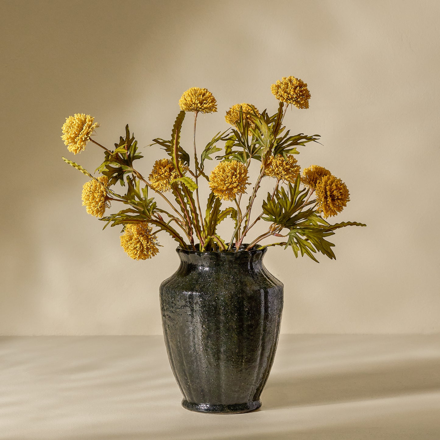 Yellow Large Thistle Bush shown in black vase