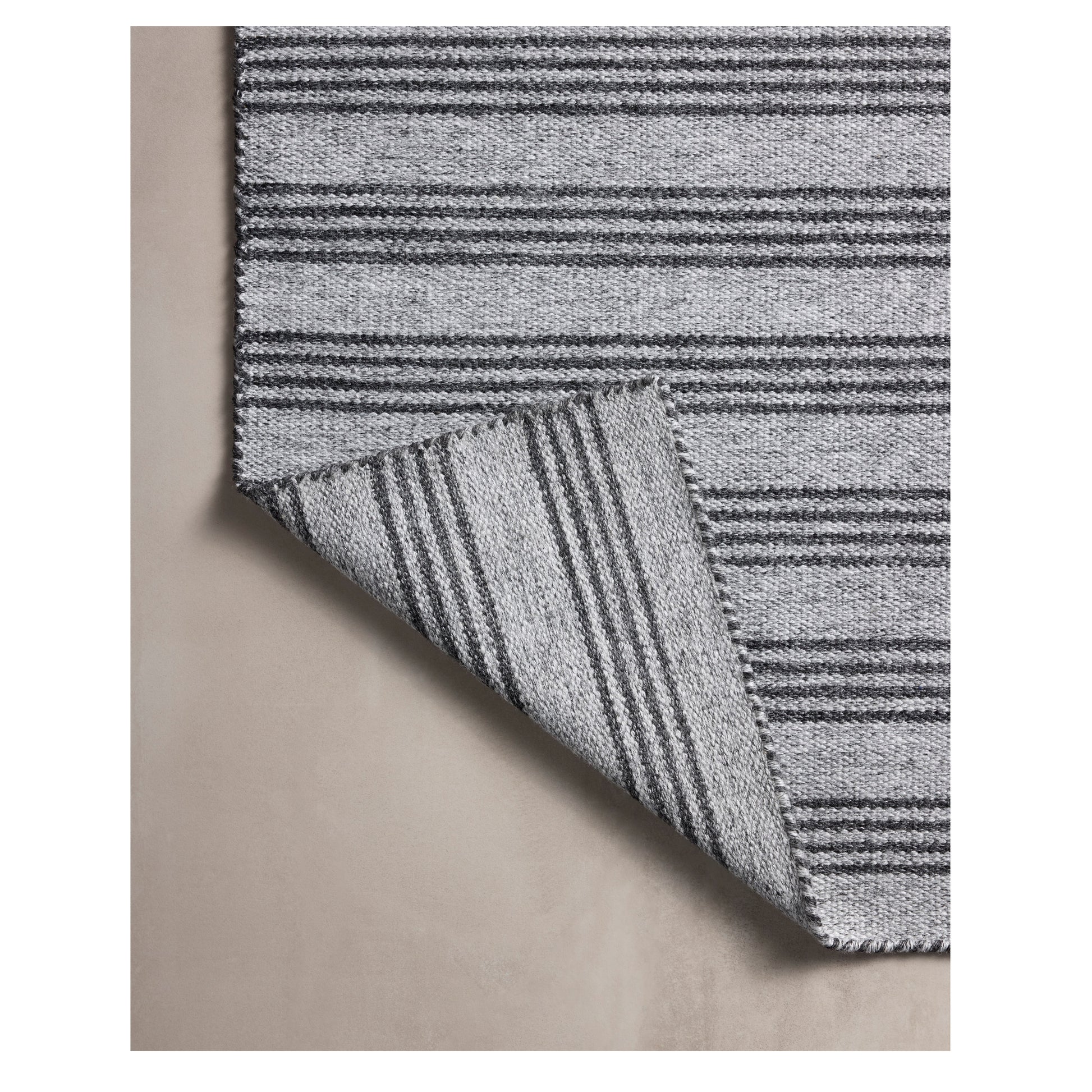 Charlie Dove Charcoal Rug corner folded back