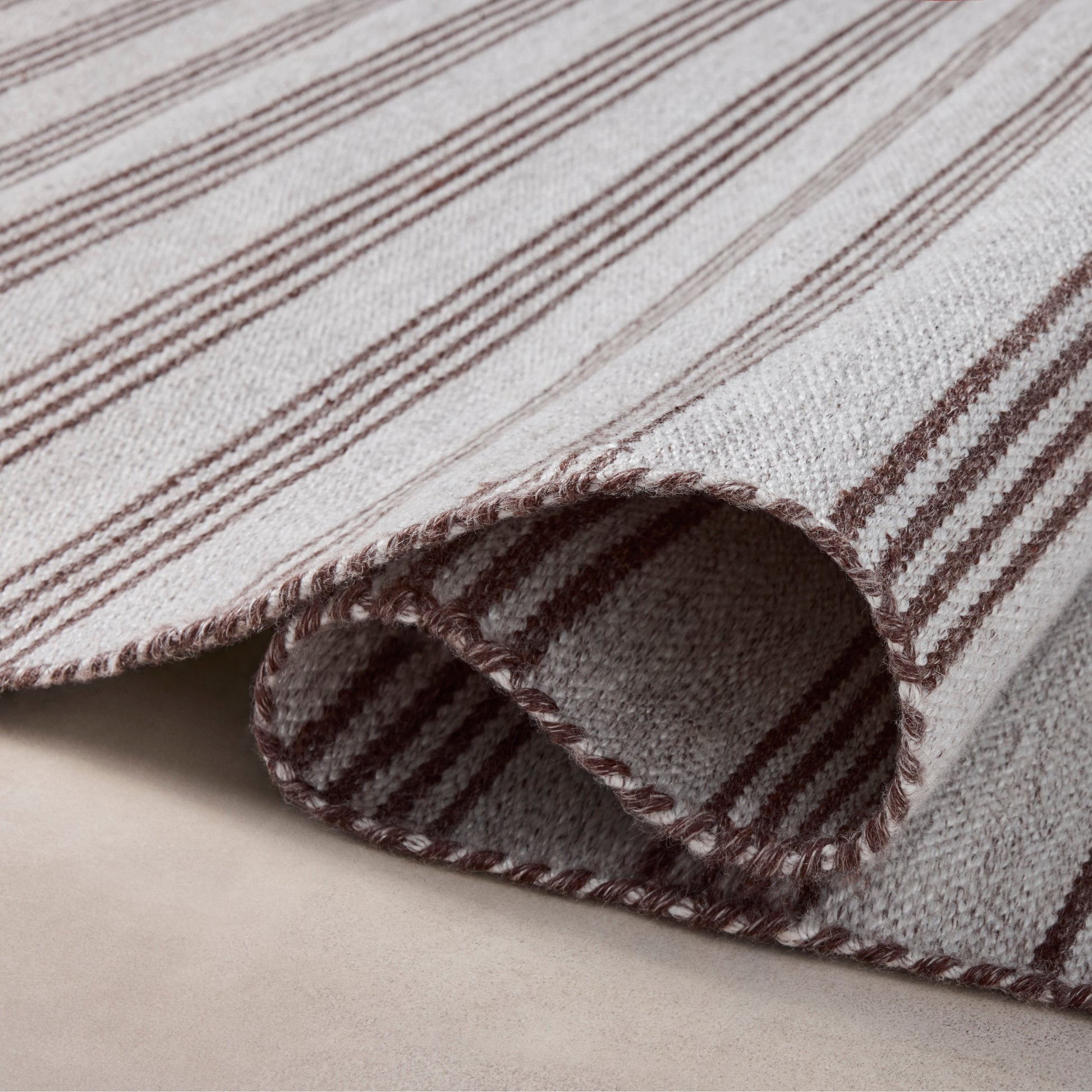 Charlie Silver Bark Rug close up of rolled rug