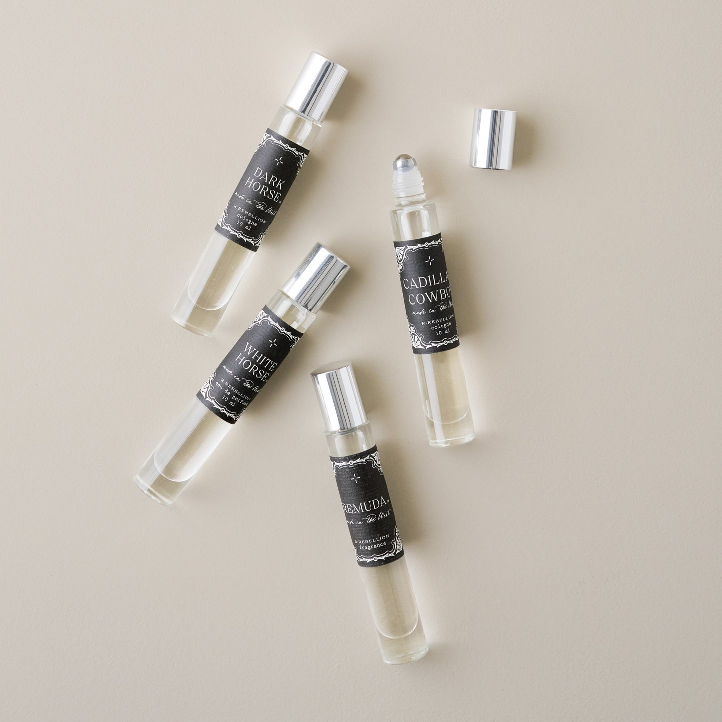 Cadillac Cowboy Roll On Cologne Oil shown with other colognes