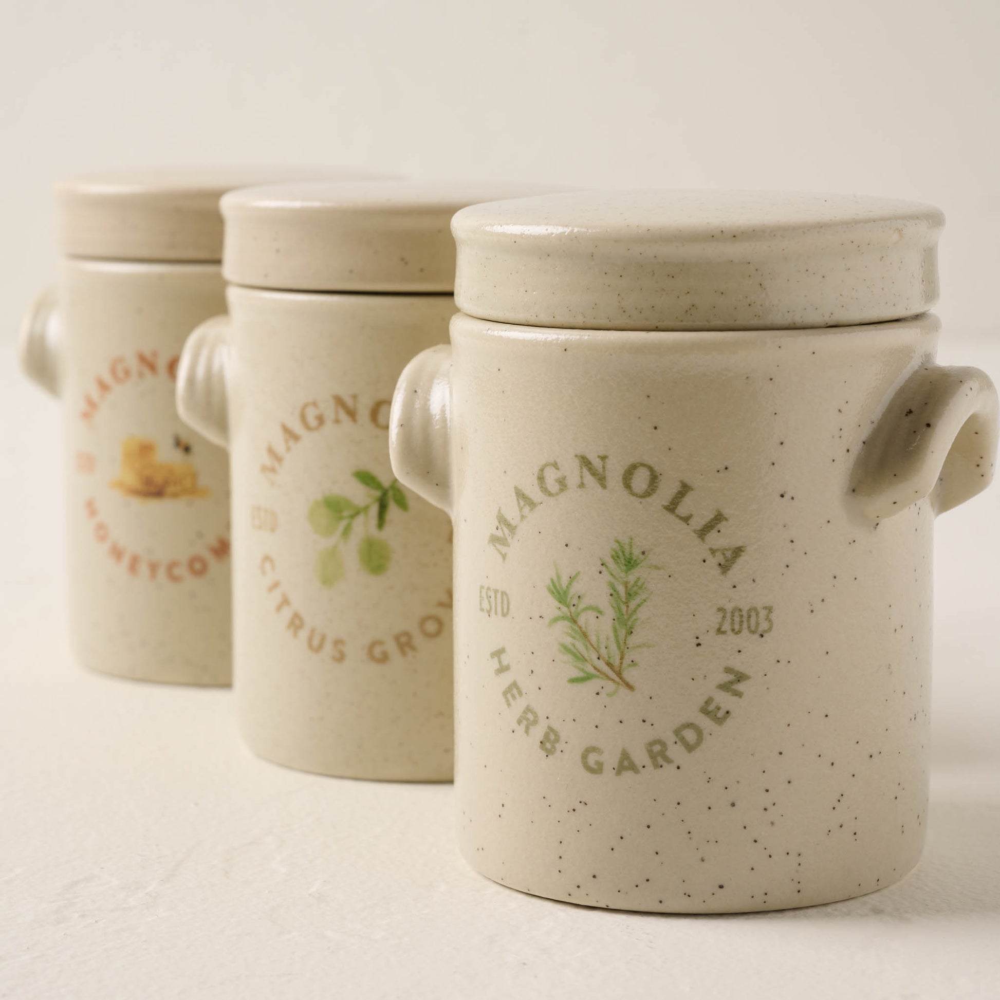 citrus grove candle lined up with honeycomb and herb garden candles