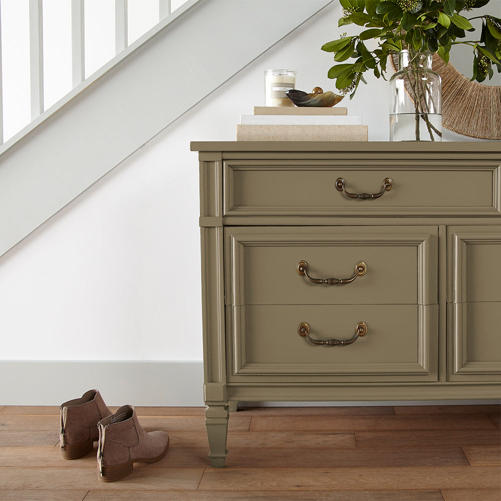rich green with brown undertone paint color named remote trail shown painted on cabinet
