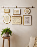 Colleen Brass Rail Photo Gallery styled in a room above plant stand
