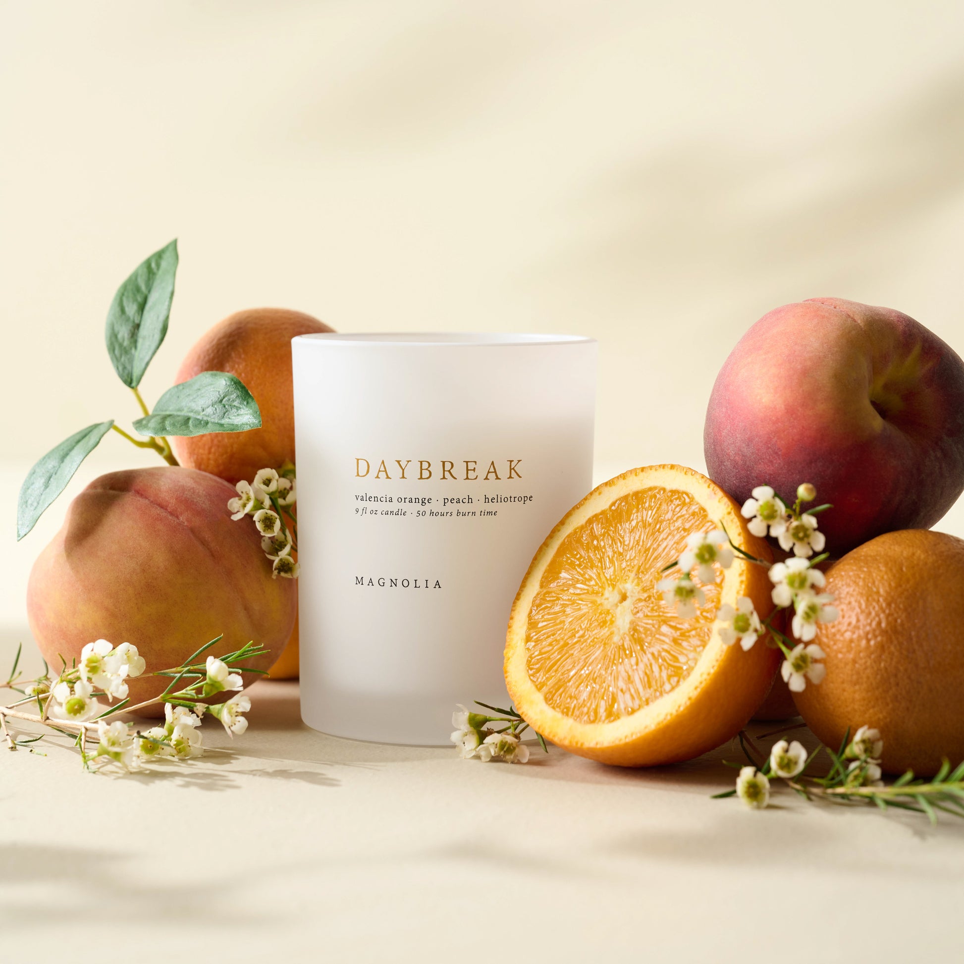 Magnolia Daybreak Candle with peaches, oranges and flowers