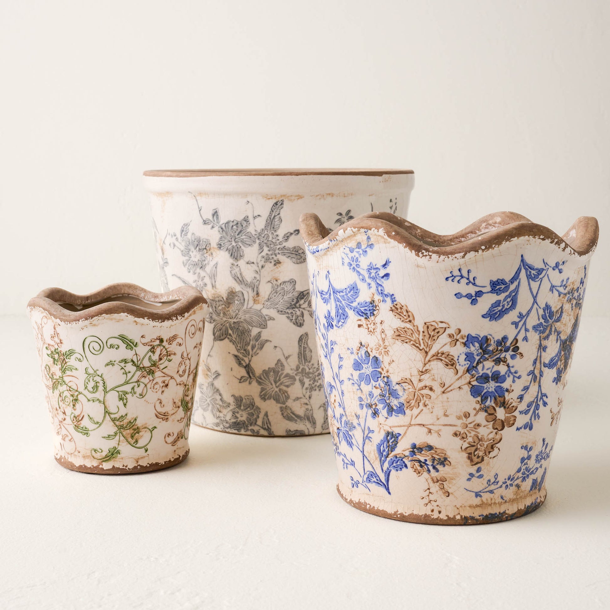 Blue Scalloped Distressed Planter with green and black and white distressed planters