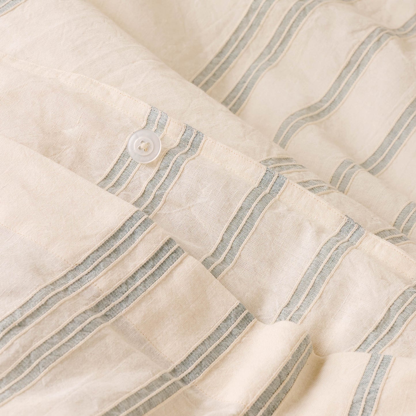 Button detail on Embroidered Chambray Stripe Linen Cotton Duvet