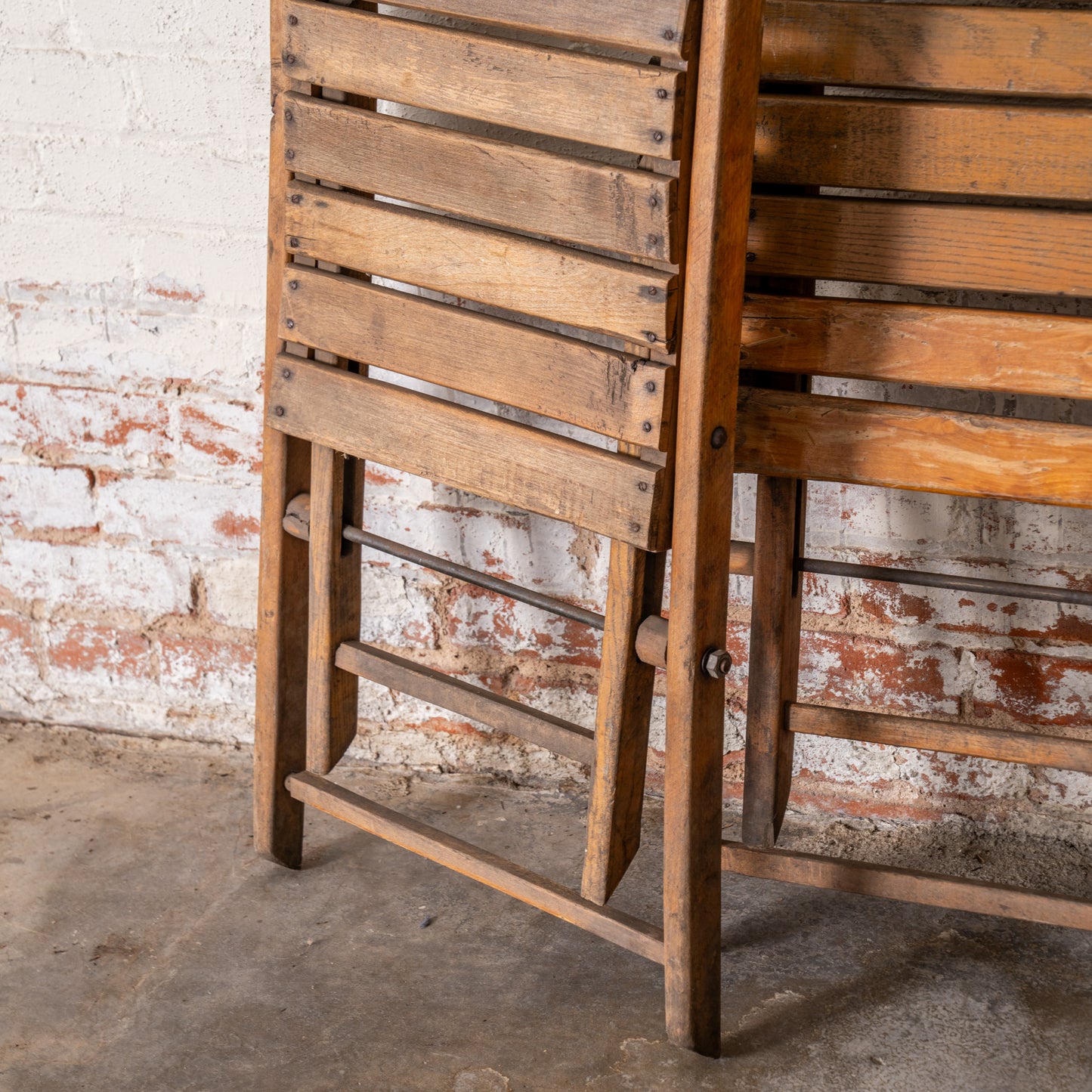 Vintage Wooden German Folding Chair legs shown close up leaning up against wall
