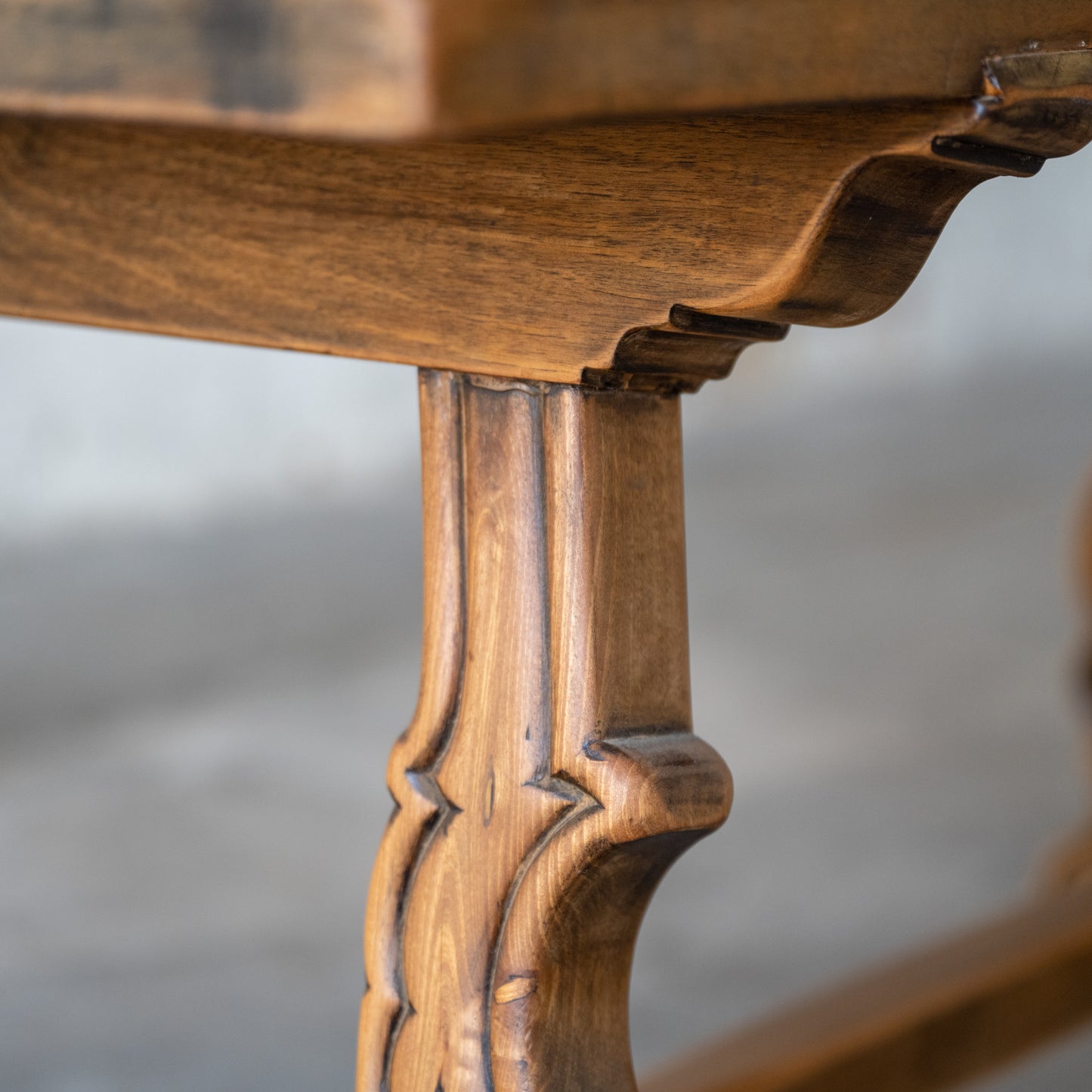 Antique Solid Oak Spanish Colonial Table close up of wood carving detail on leg of table