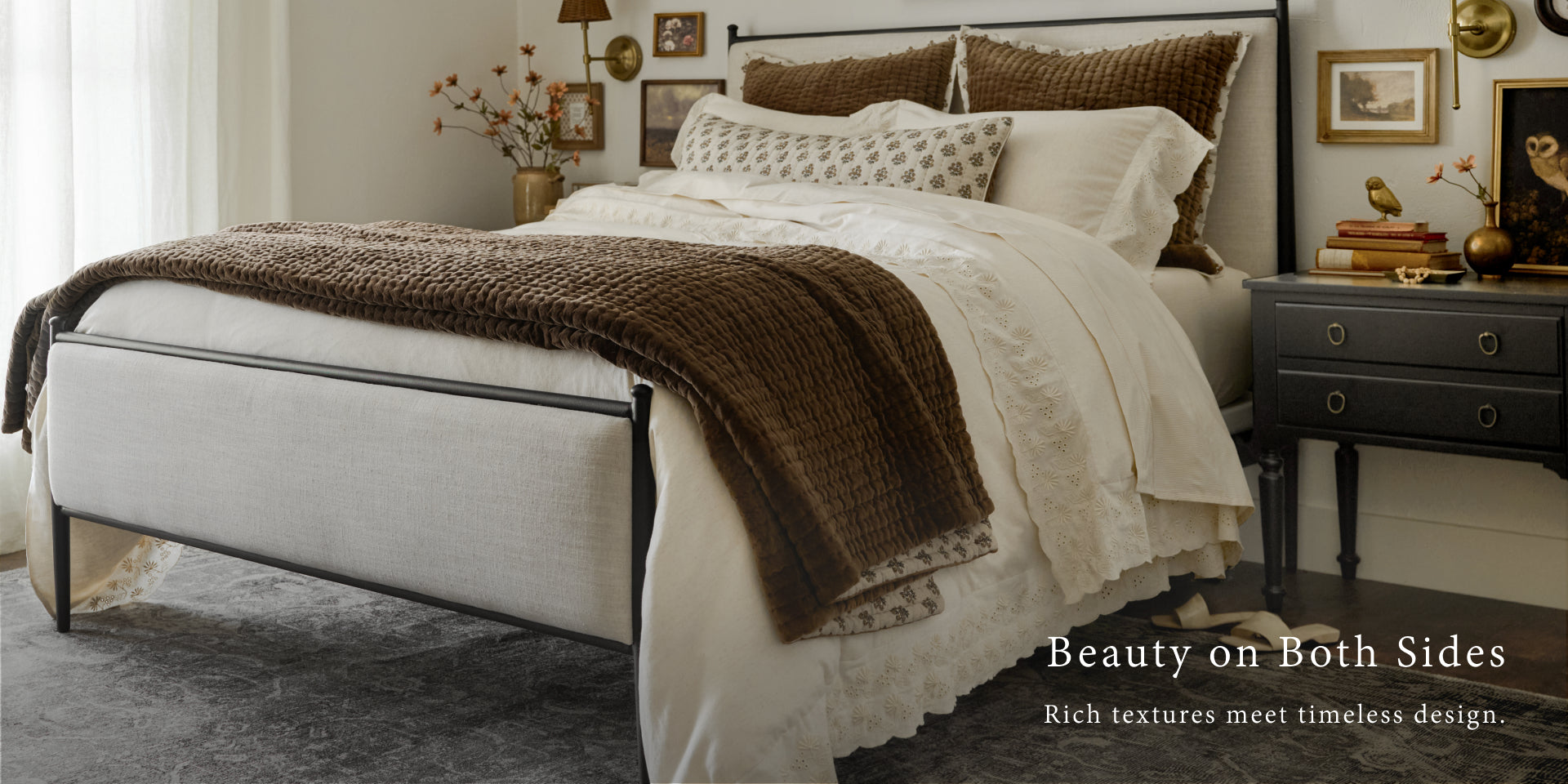 Neatly made bed with brown and white bedding in a bedroom setting. Shop Bedding.