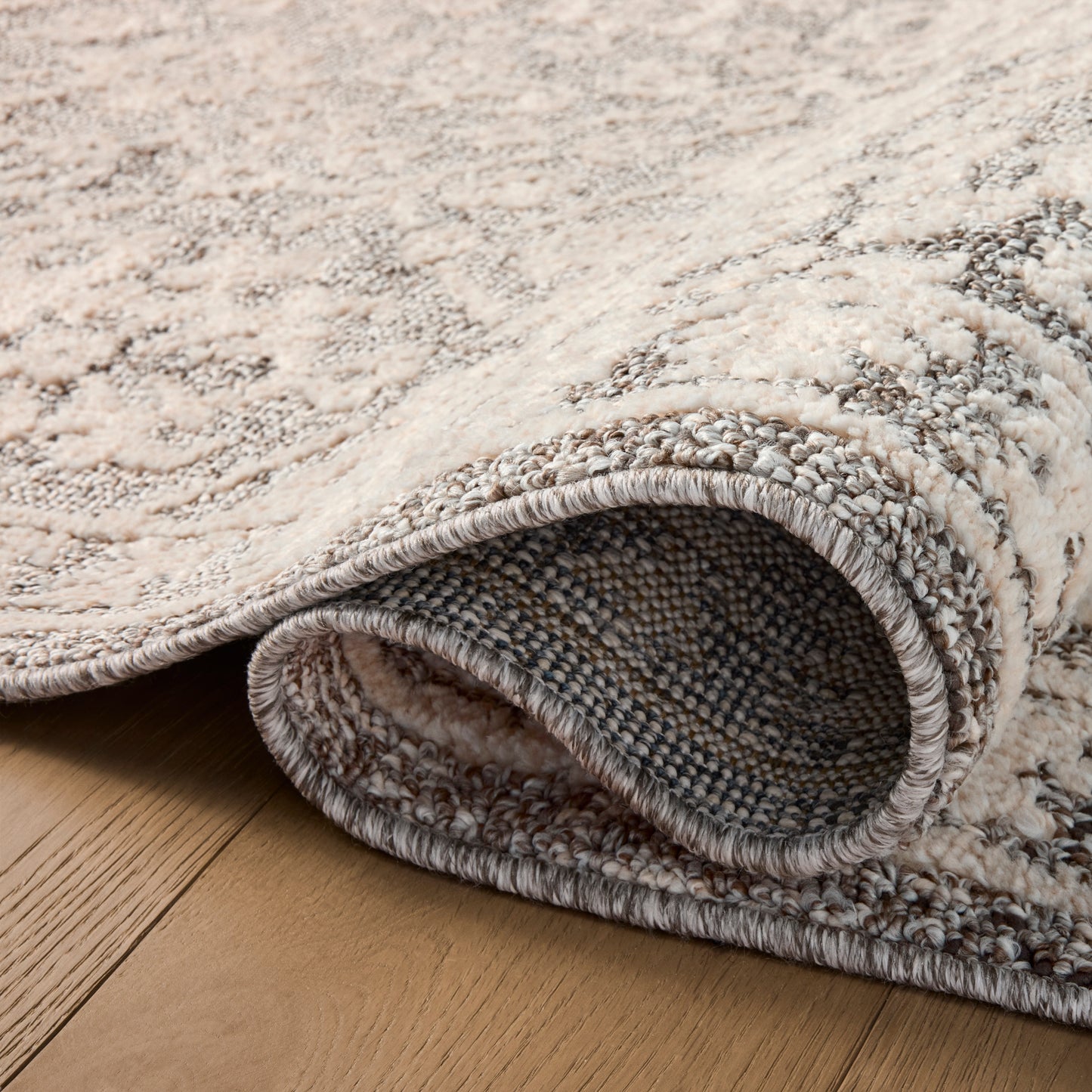 Gigi Grey Ivory Rug close up of rolled rug
