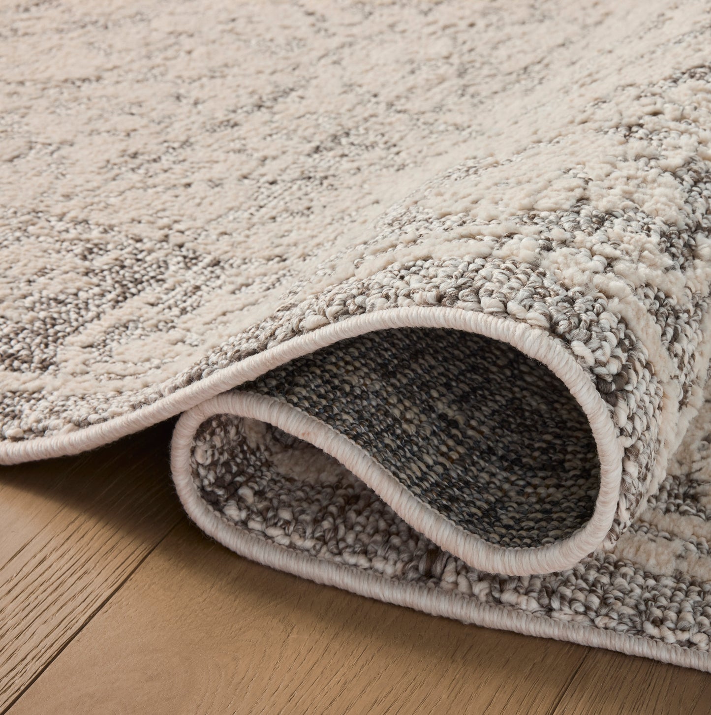 Gigi Ivory Stone Rug close up of rolled rug
