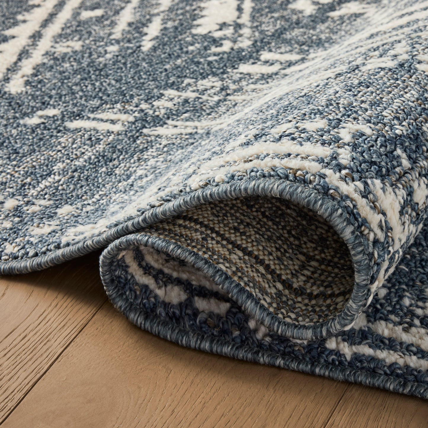 Gigi Denim Ivory Rug close up of rolled rug