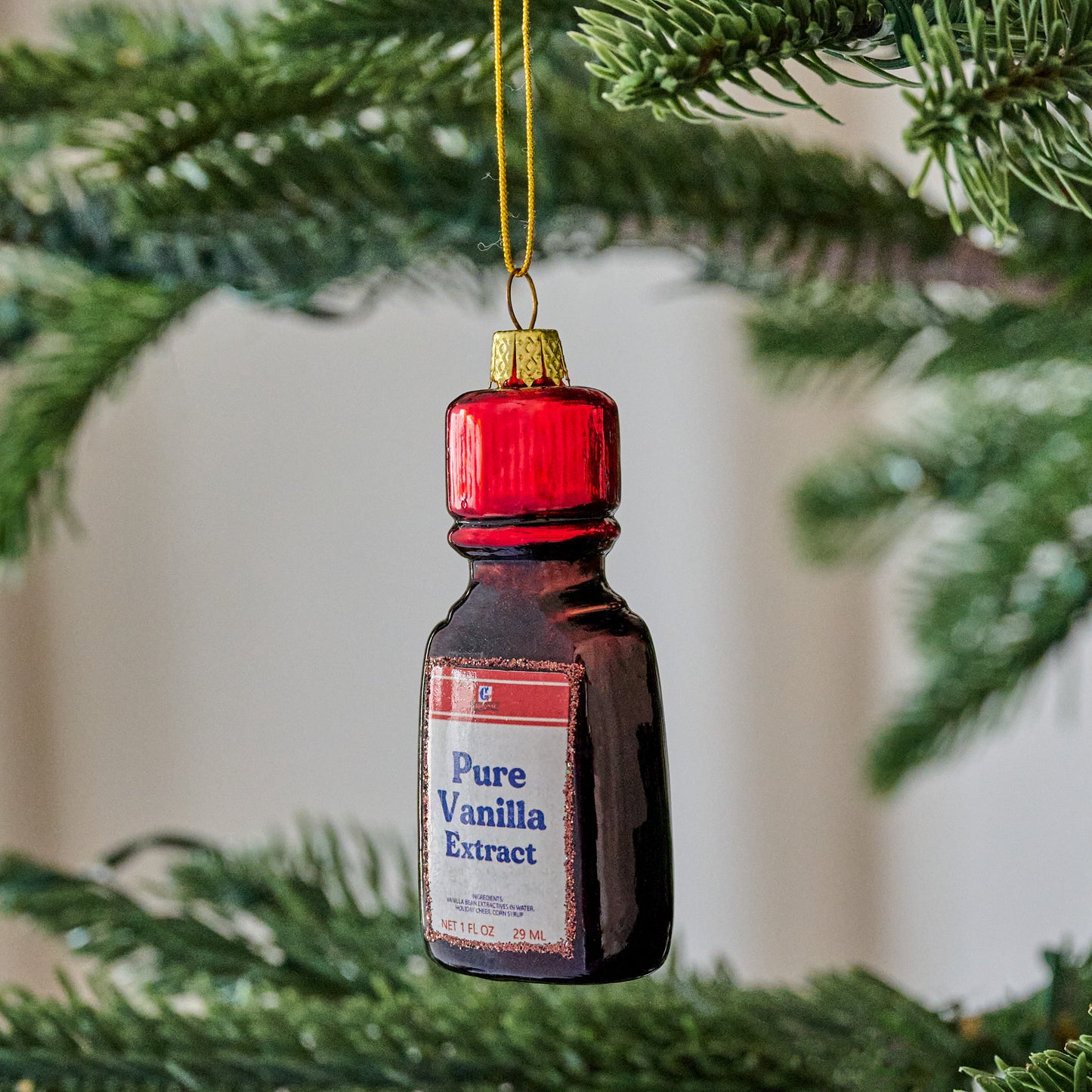 Vanilla Extract Ornament shown hung from tree