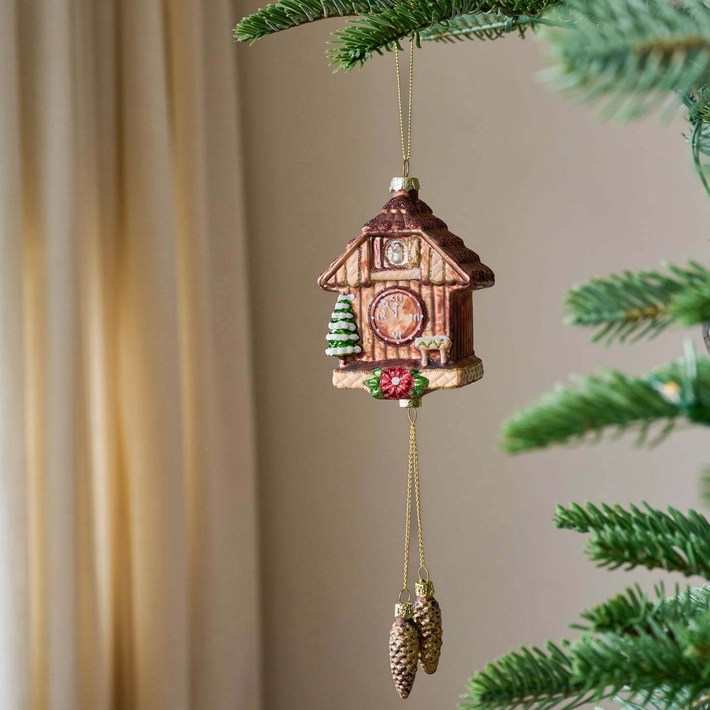 Vintage Cuckoo Clock Ornament shown hung from tree