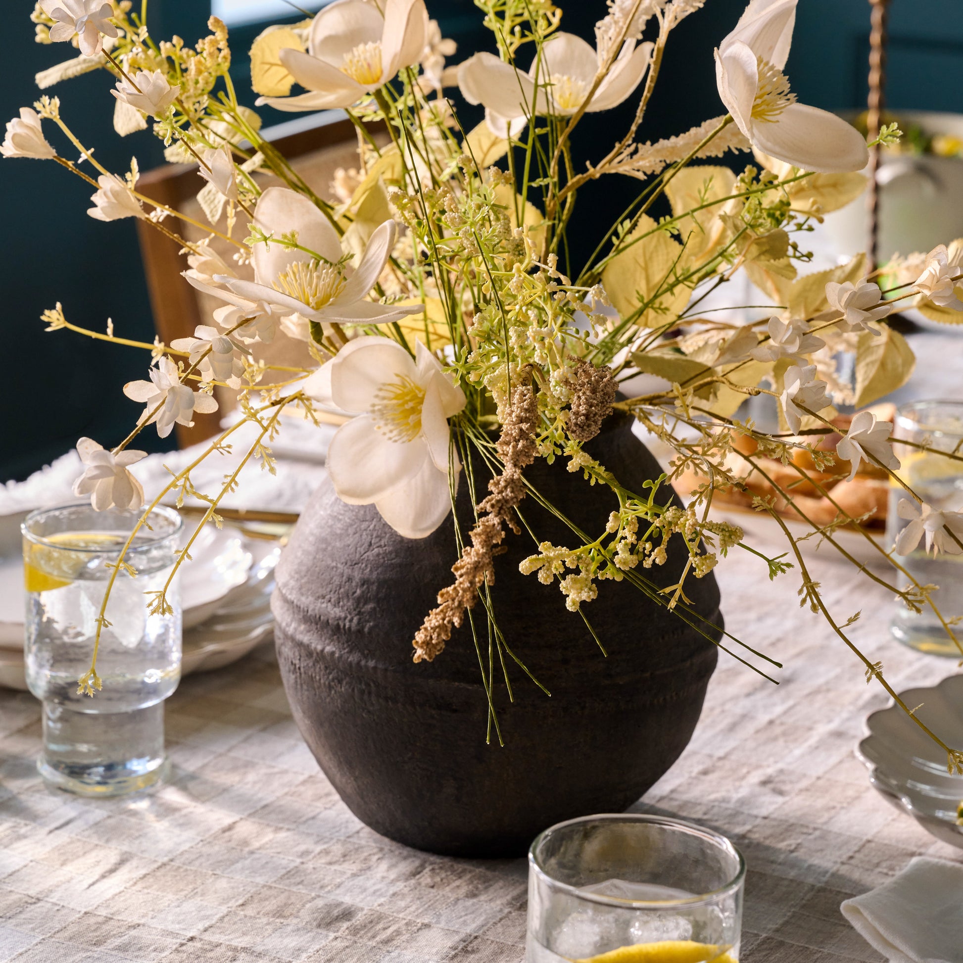 Black Round Concrete Vase with florals on a table top