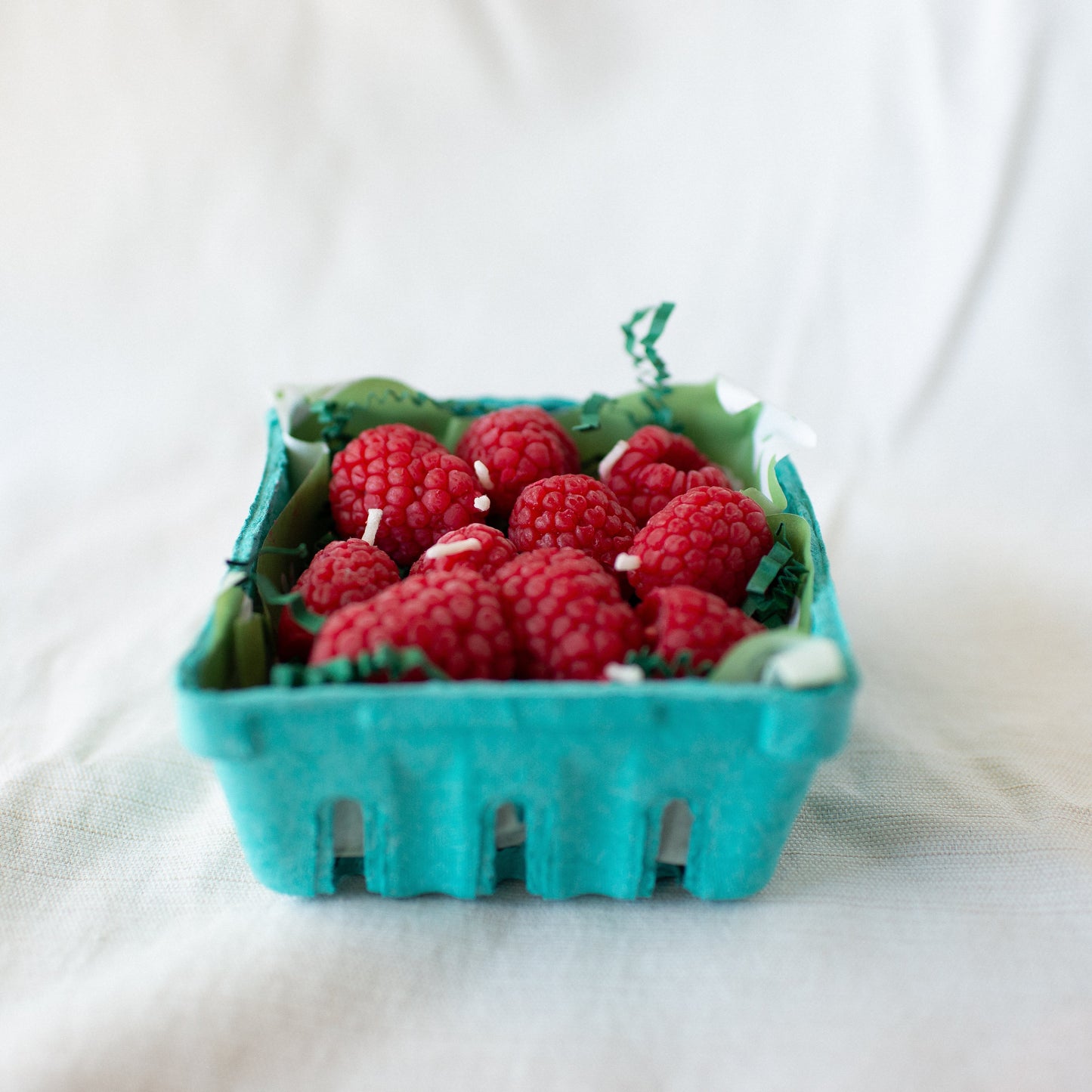 Raspberry Birthday Candle Set of 10 shown up cose in carton