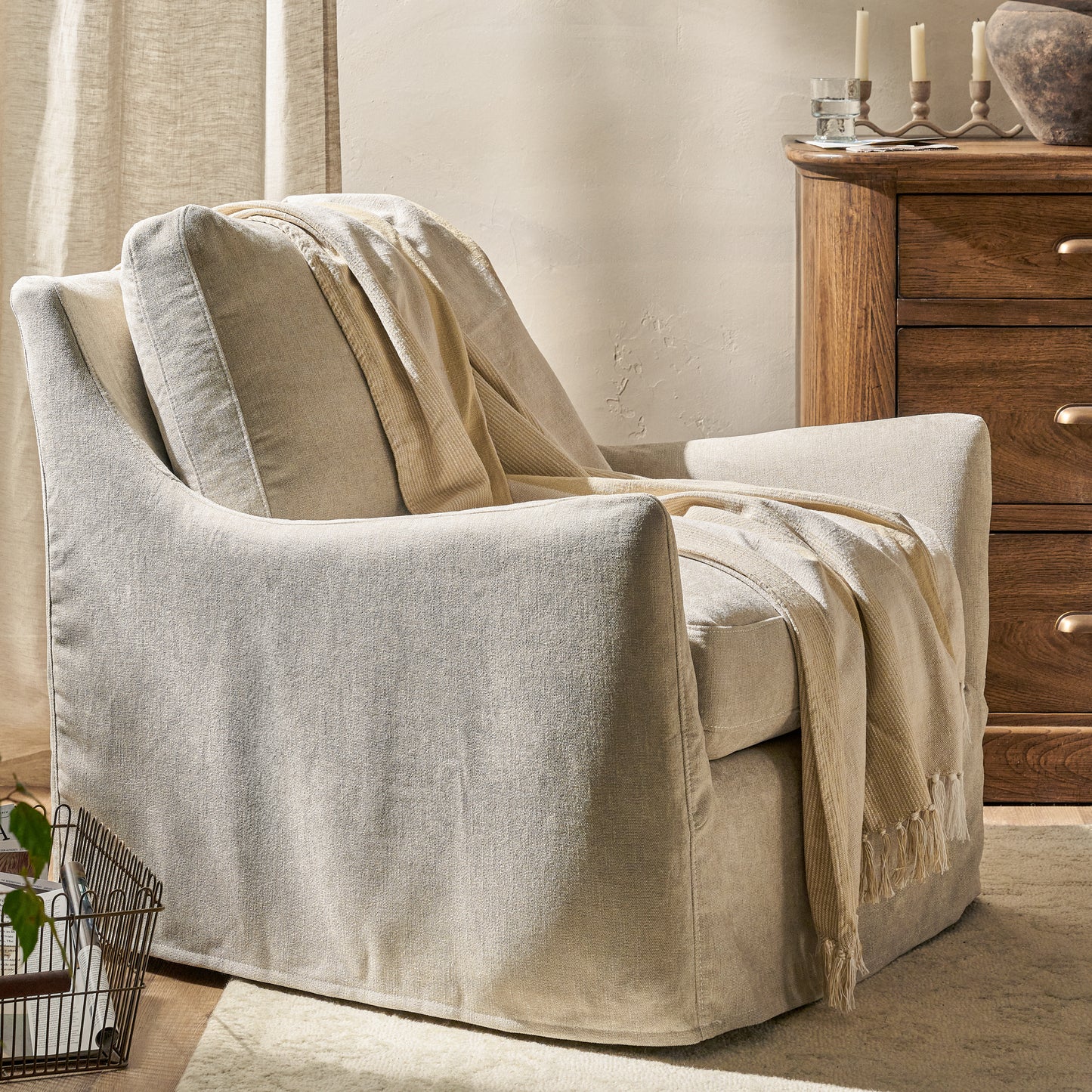Sabine Slipcover Swivel Chair in shell in a room