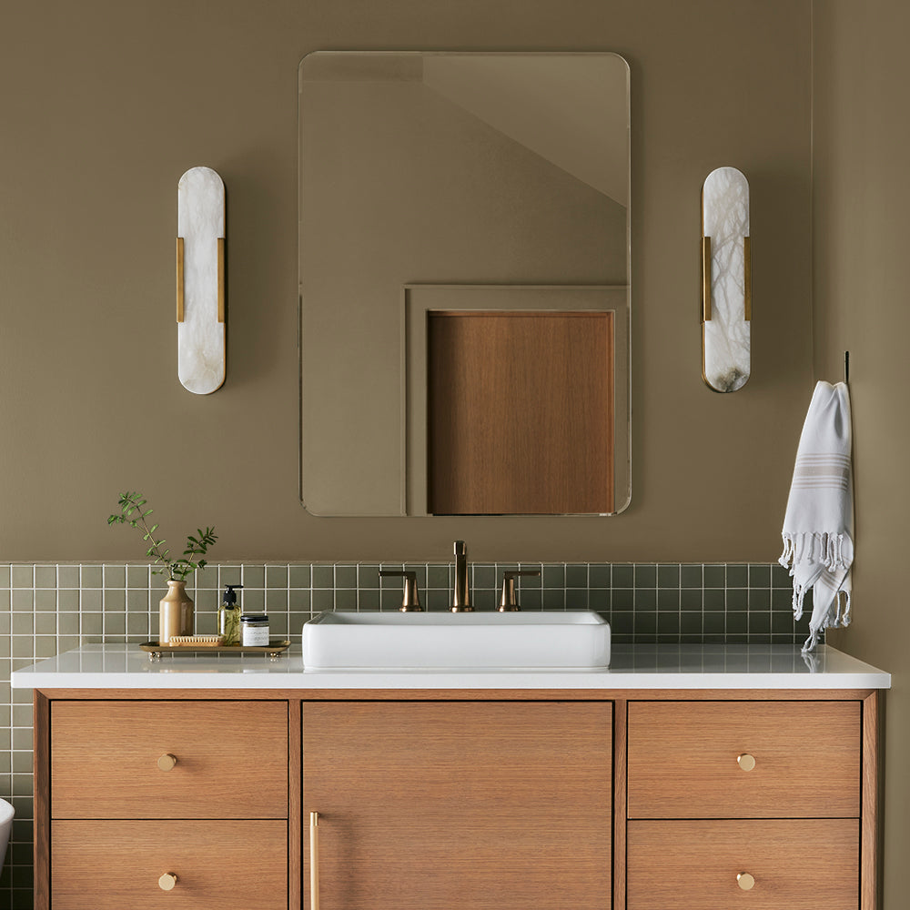 rich green with brown undertone paint color named remote trail shown painted on bathroom wall