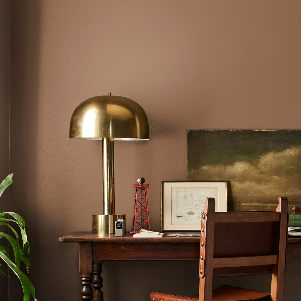 earthy brown with reddish hue paint color named cognac shown painted on bedroom wall