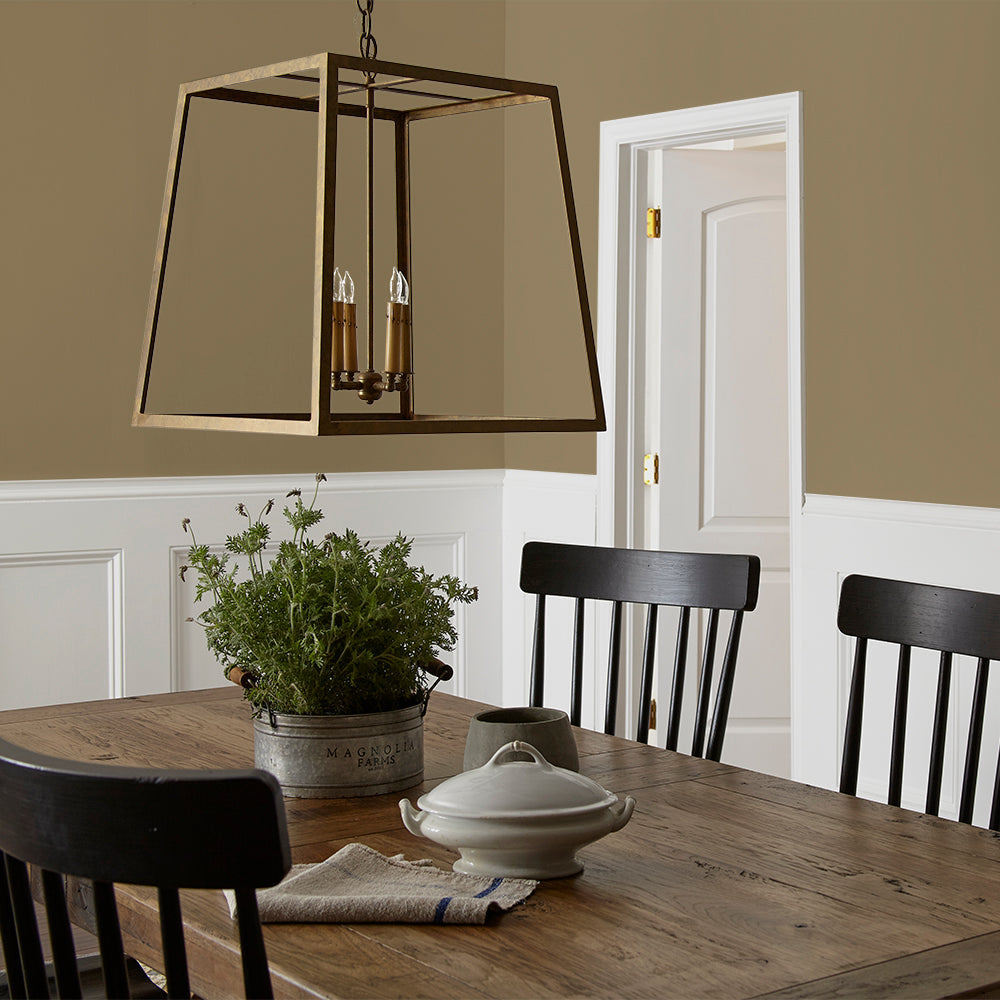 rich green with brown undertone paint color named remote trail shown painted on dining room wall