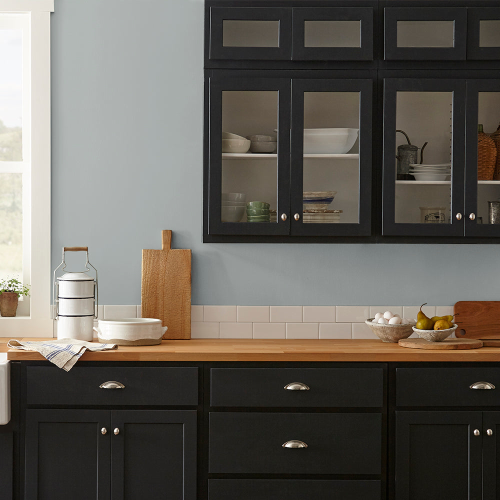 neutral grey with a tinge of blue paint color named tranquil waters shown painted on kitchen wall