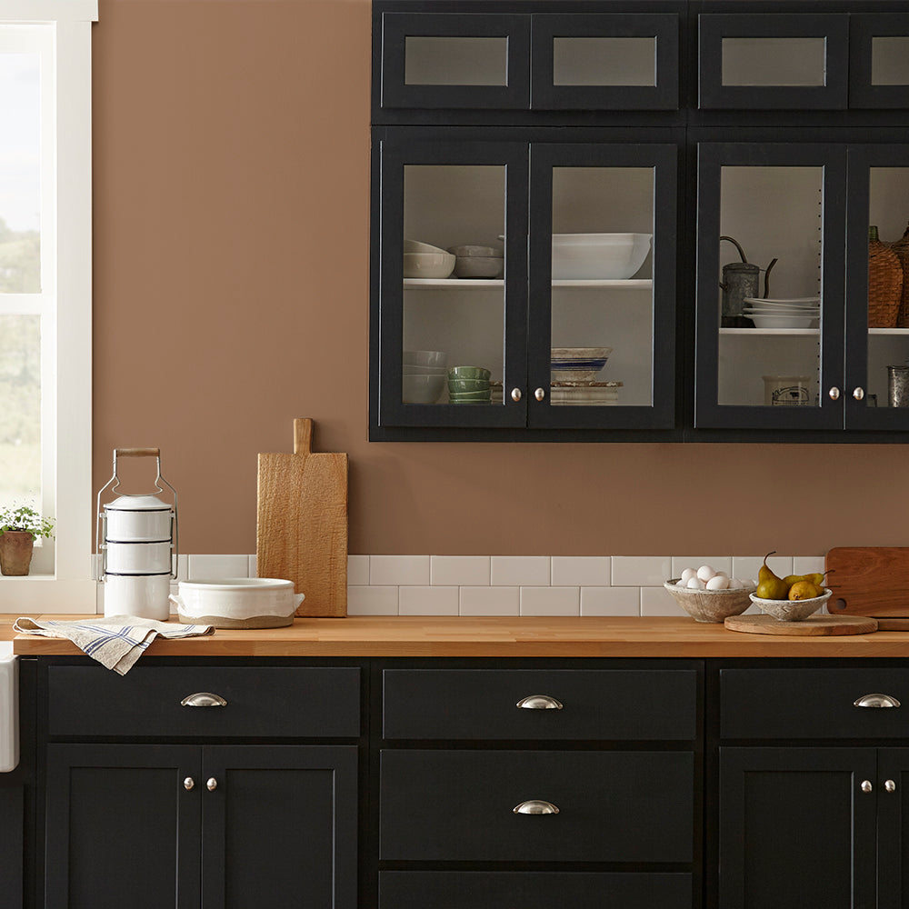earthy brown with reddish hue paint color named cognac shown painted on kitchen wall