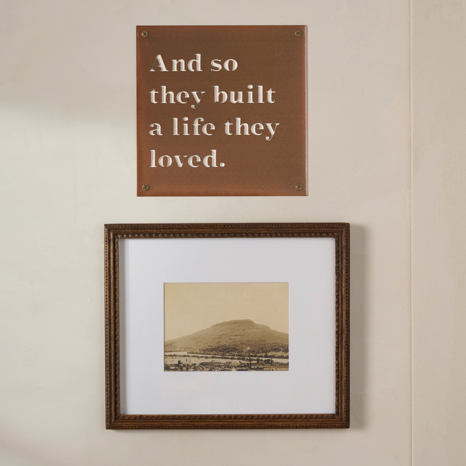 And So They Built A Life They Loved Sign shown hung above framed image