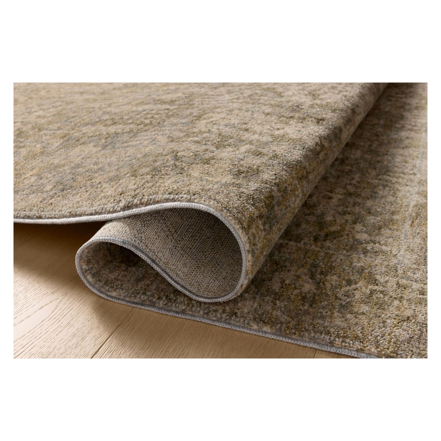 Junie Moss Natural Rug shown rolled over itself